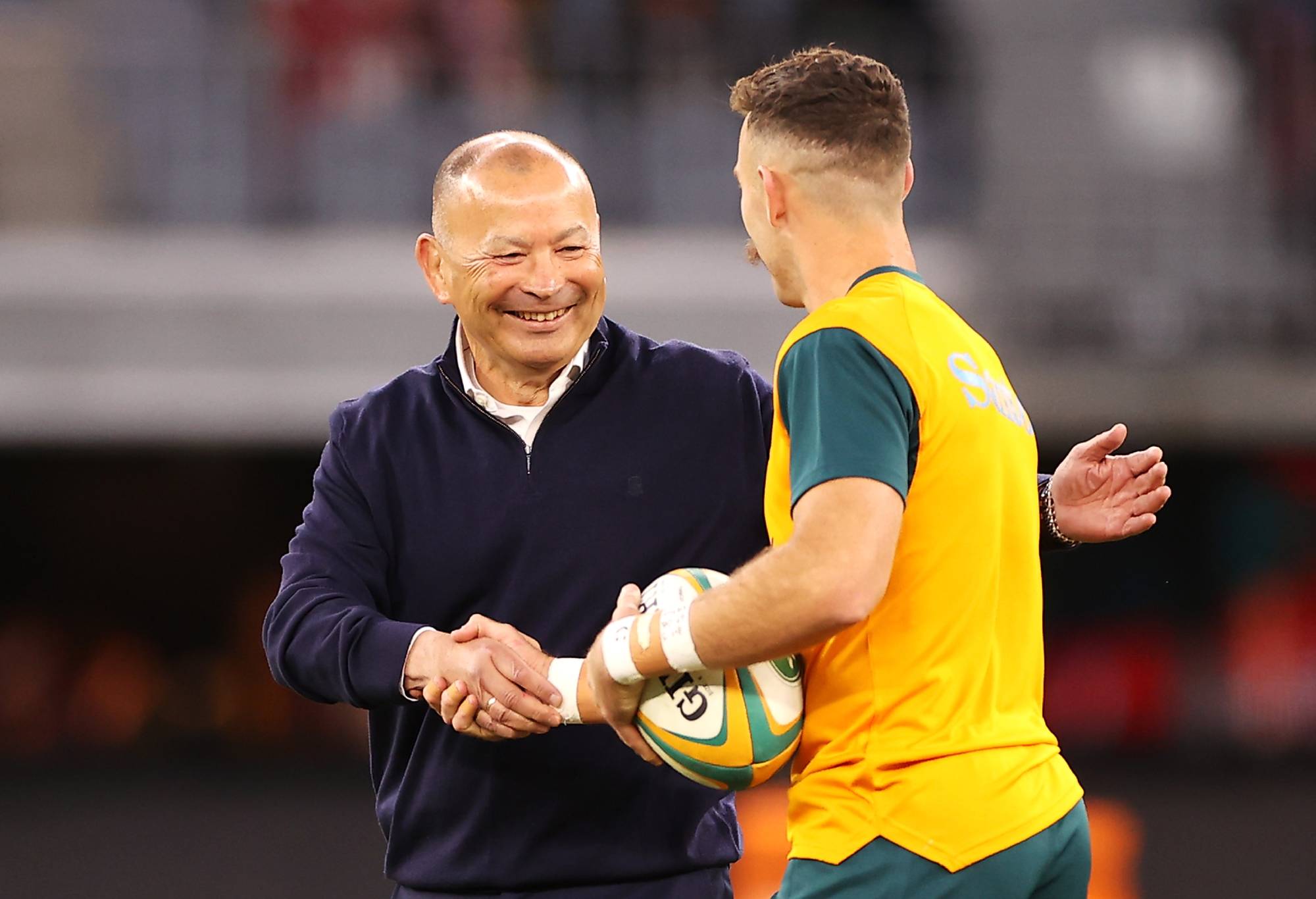 PERTH, AUSTRALIA - JULY 02: England coach Eddie Jones shakes hands with Nic White of the Wallabies during the warm-up before game one of the international test match series between the Australian Wallabies and England at Optus Stadium on July 02, 2022 in Perth, Australia. (Photo by Mark Kolbe/Getty Images)