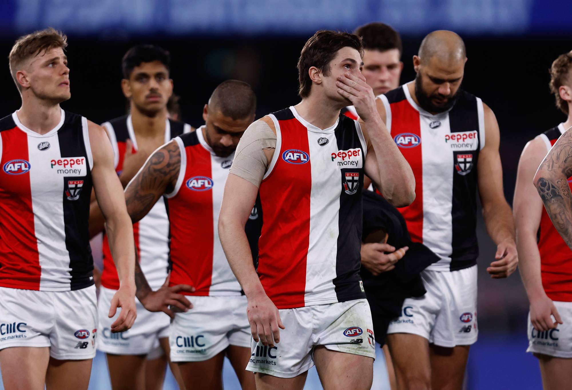 MELBOURNE, AUSTRALIA - JULY 15: Dejected St Kilda players walks from the ground after the round 18 AFL match between the Western Bulldogs and the St Kilda Saints at Marvel Stadium on July 15, 2022 in Melbourne, Australia. (Photo by Darrian Traynor/Getty Images)