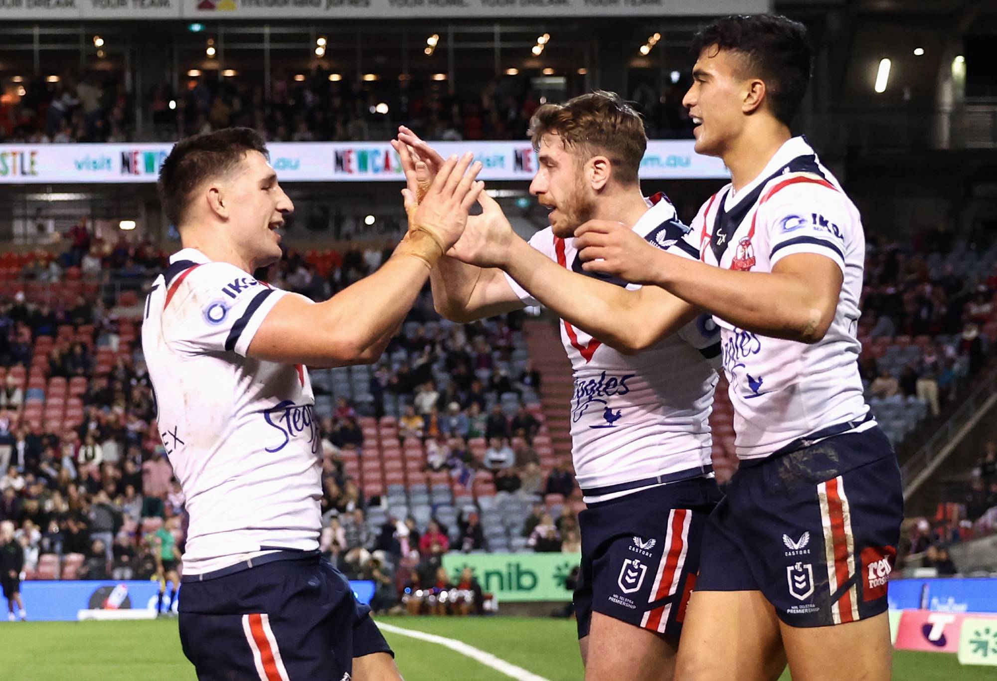 NEWCASTLE, AUSTRALIA - JULY 22: Jospeh Suaalii of the Roosters celebrates scoring a try with team mates during the round 19 NRL match between the Newcastle Knights and the Sydney Roosters at McDonald Jones Stadium, on July 22, 2022, in Newcastle, Australia. (Photo by Matt King/Getty Images)