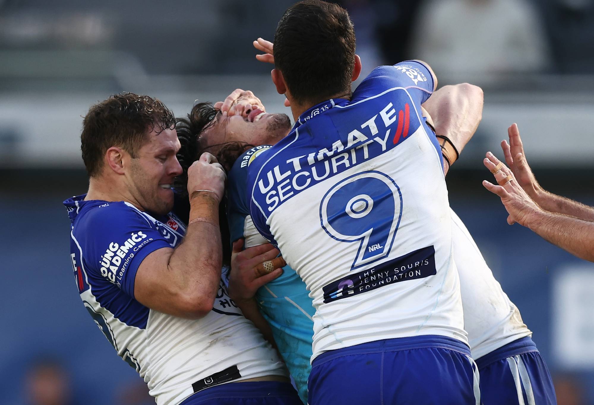 SYDNEY, AUSTRALIA - JULY 24: Corey Waddell of the Bulldogs tackles Tino Fa'asuamaleaui of the Titans with his hands on his eyes during the round 19 NRL match between the Canterbury Bulldogs and the Gold Coast Titans at CommBank Stadium, on July 24, 2022, in Sydney, Australia. (Photo by Matt King/Getty Images)