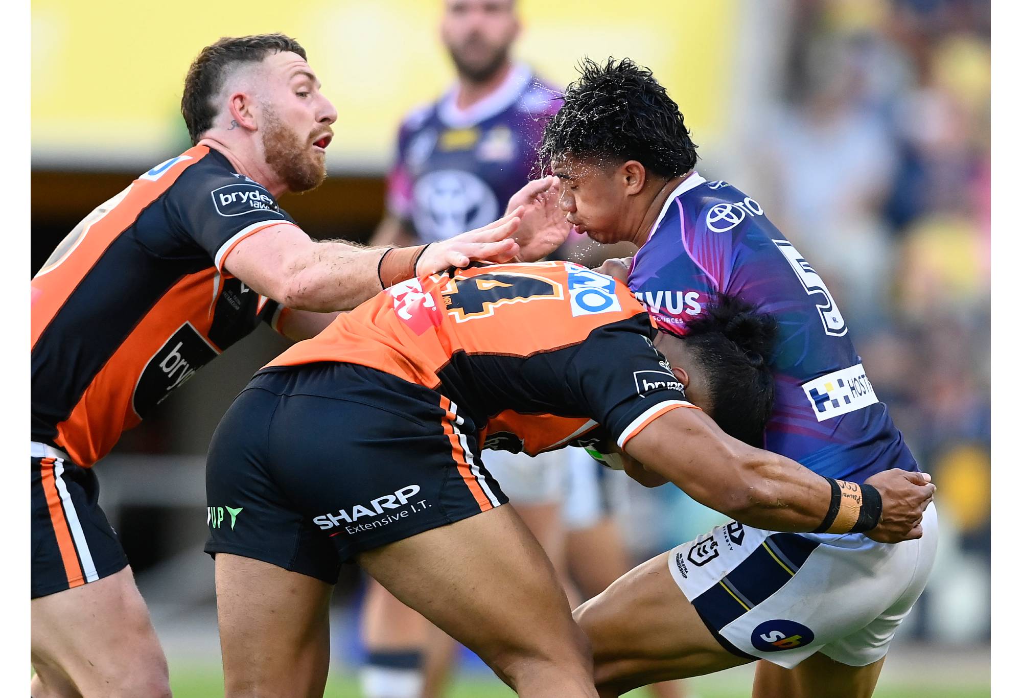 TOWNSVILLE, AUSTRALIA - JULY 24: Murray Taulagi of the Cowboys is tackled during the round 19 NRL match between the North Queensland Cowboys and the Wests Tigers at Qld Country Bank Stadium, on July 24, 2022, in Townsville, Australia. (Photo by Ian Hitchcock/Getty Images)