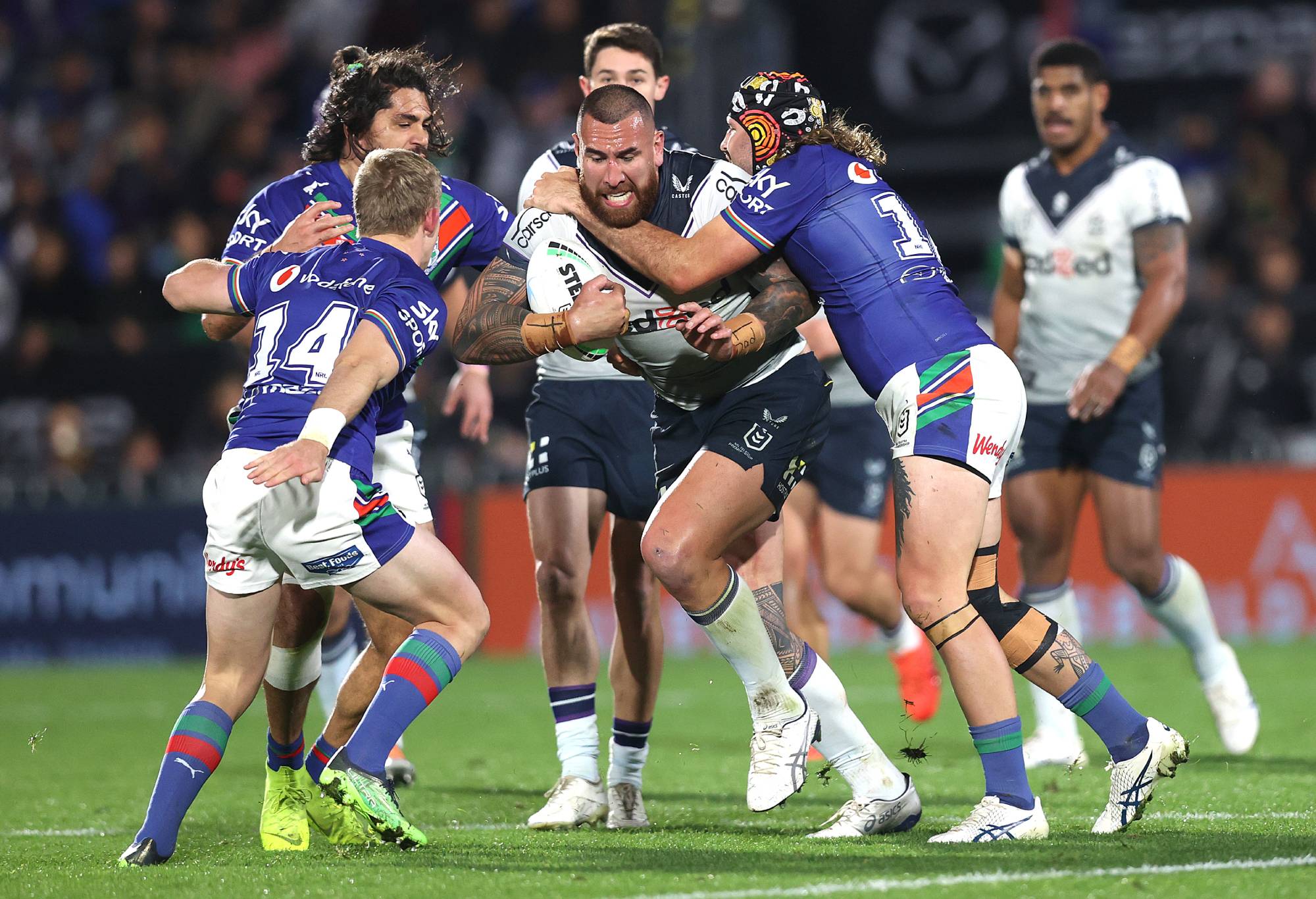 AUCKLAND, NEW ZEALAND - JULY 29: Nelson Asofa-Solomona of the Storm runs is tackled by Josh Curran of the Warriors during the round 20 NRL match between the New Zealand Warriors and the Melbourne Storm at Mt Smart Stadium, on July 29, 2022, in Auckland, New Zealand. (Photo by Phil Walter/Getty Images)