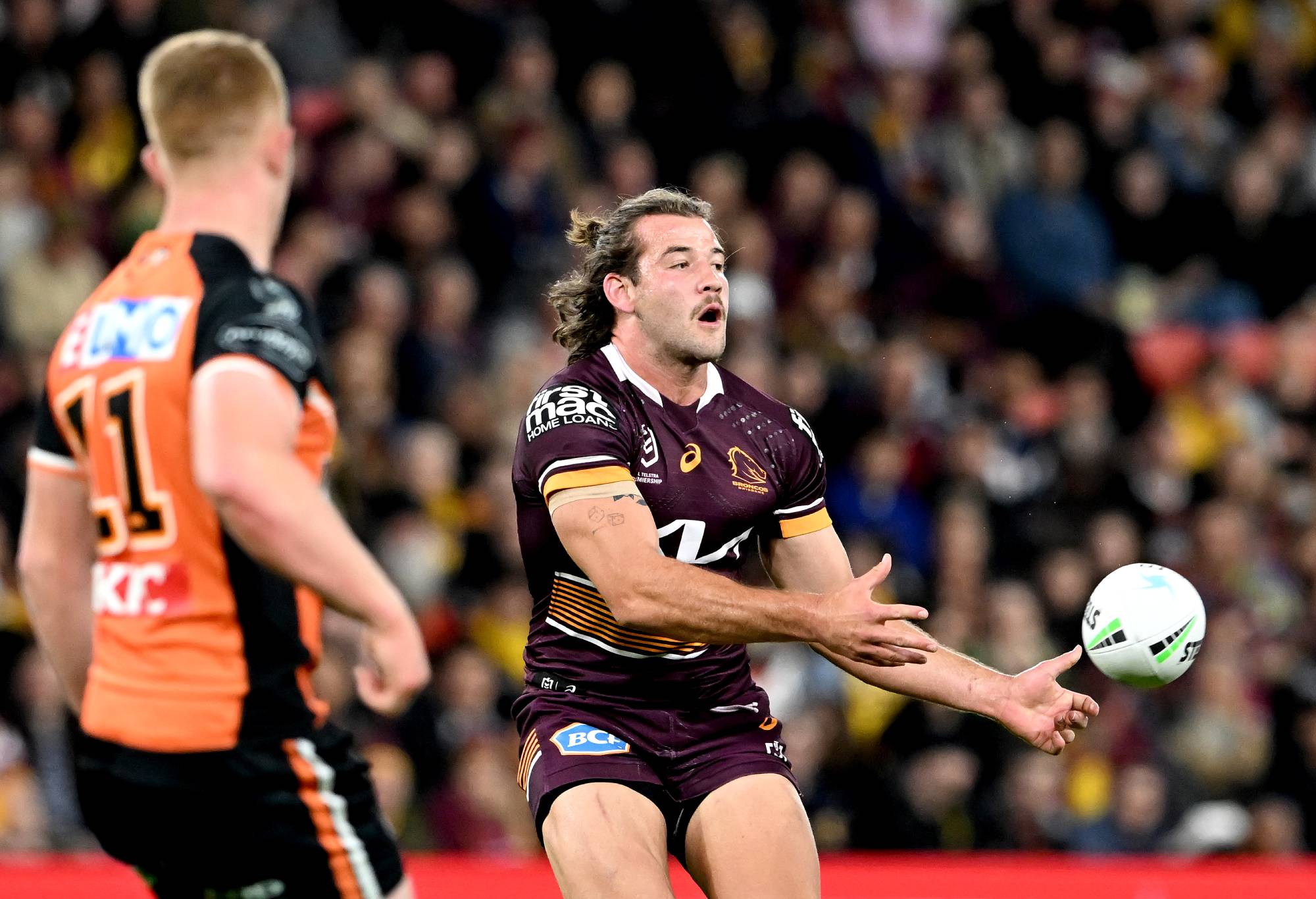 BRISBANE, AUSTRALIA - JULY 30: Patrick Carrigan of the Broncos passes the ball during the round 20 NRL match between the Brisbane Broncos and the Wests Tigers at Suncorp Stadium, on July 30, 2022, in Brisbane, Australia. (Photo by Bradley Kanaris/Getty Images)
