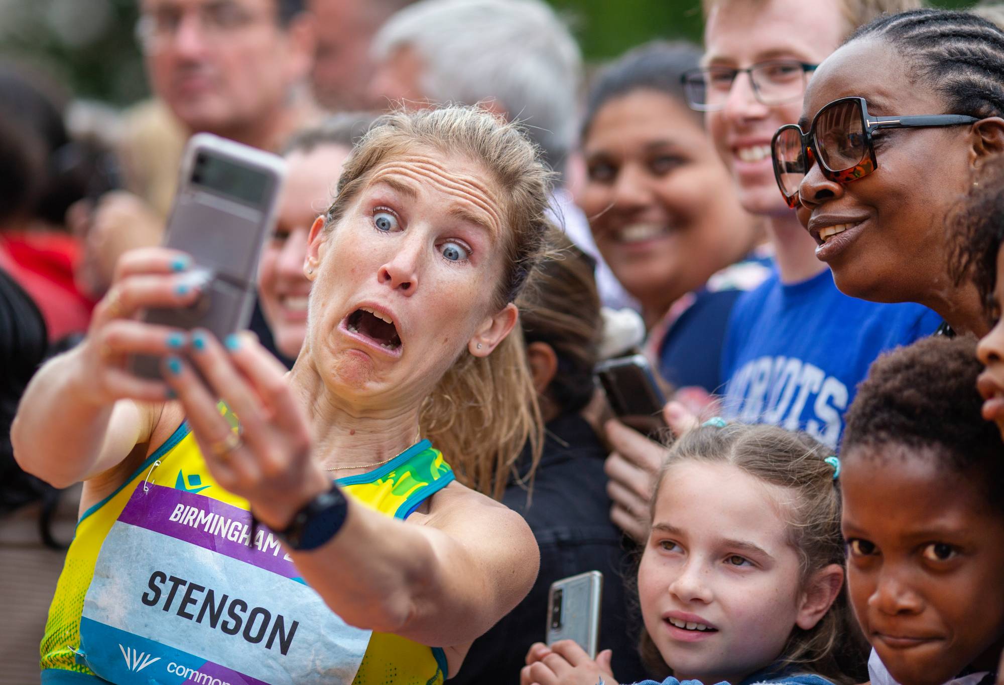 Jessica Stenson of Australia reacts as she takes selfies with spectators after winning the gold medal during the Women's Marathon at the Birmingham 2022 Commonwealth Games at Victoria Square, Birmingham City Centre on July 30, 2022, in Birmingham, England. (Photo by Tim Clayton/Corbis via Getty Images)
