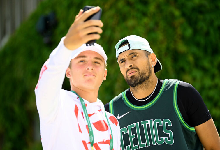 Nick Kyrgios takes a selfie with a fan