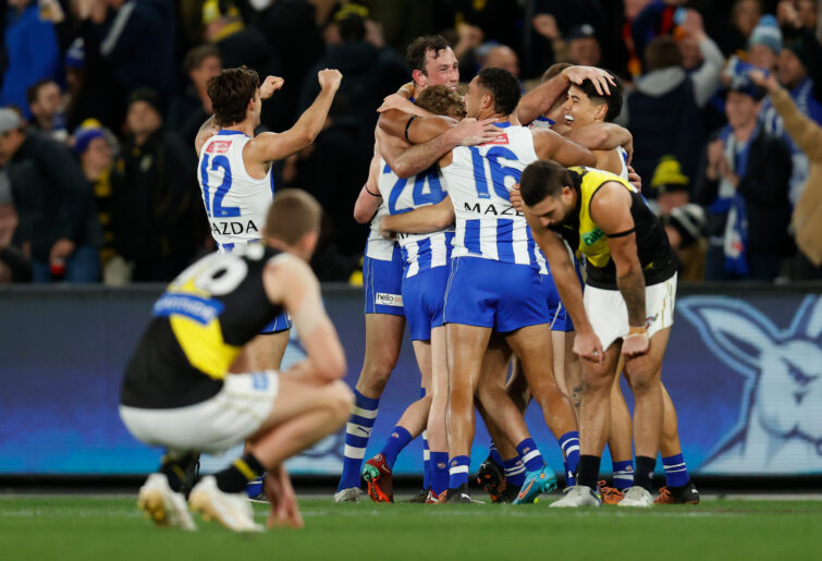 North Melbourne players celebrate defeating Richmond.