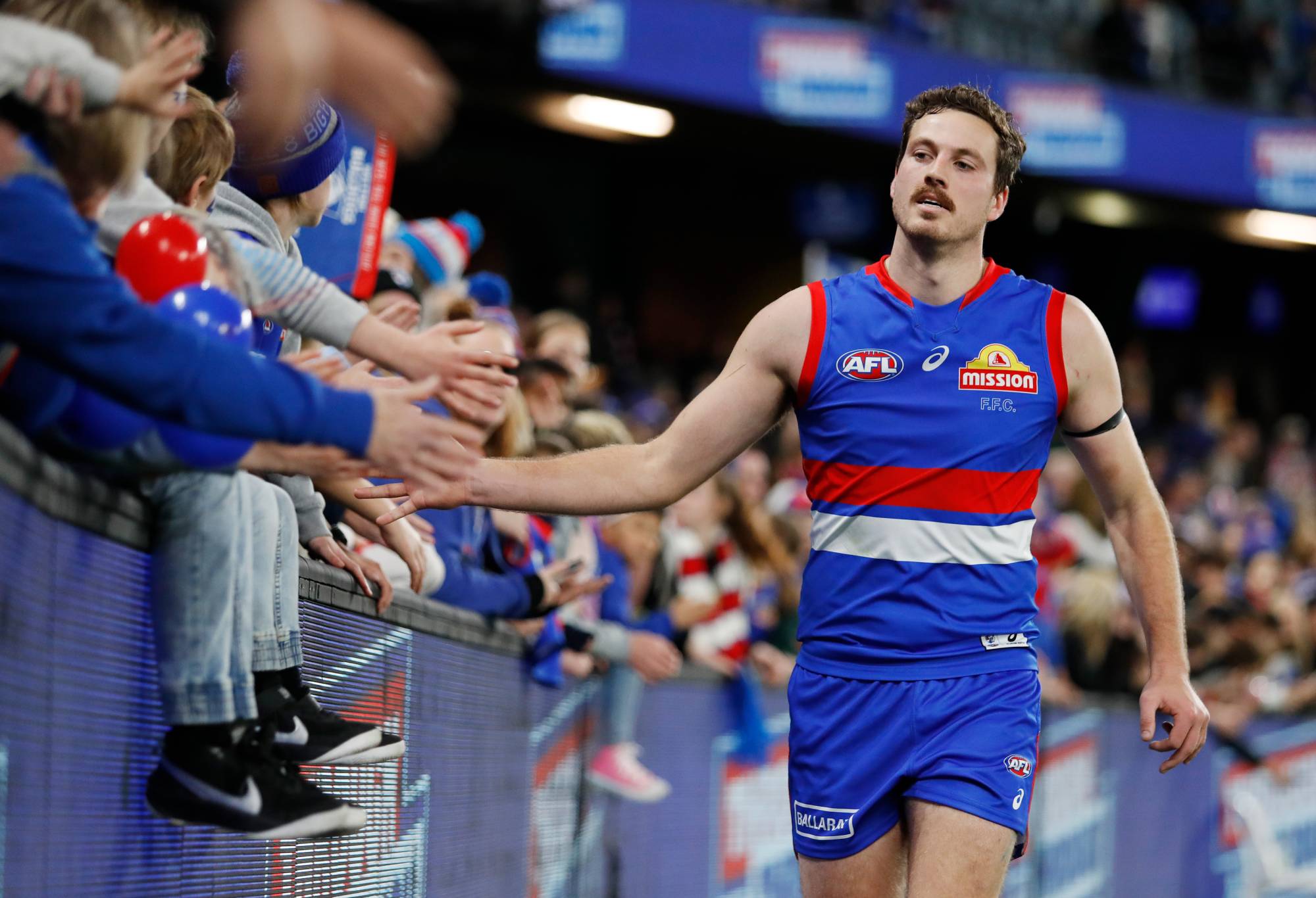 MELBOURNE, AUSTRALIA - AUGUST 13: Zaine Cordy of the Bulldogs celebrates with fans during the 2022 AFL Round 22 match between the Western Bulldogs and the GWS Giants at Marvel Stadium on August 13, 2022 in Melbourne, Australia. (Photo by Dylan Burns/AFL Photos via Getty Images)