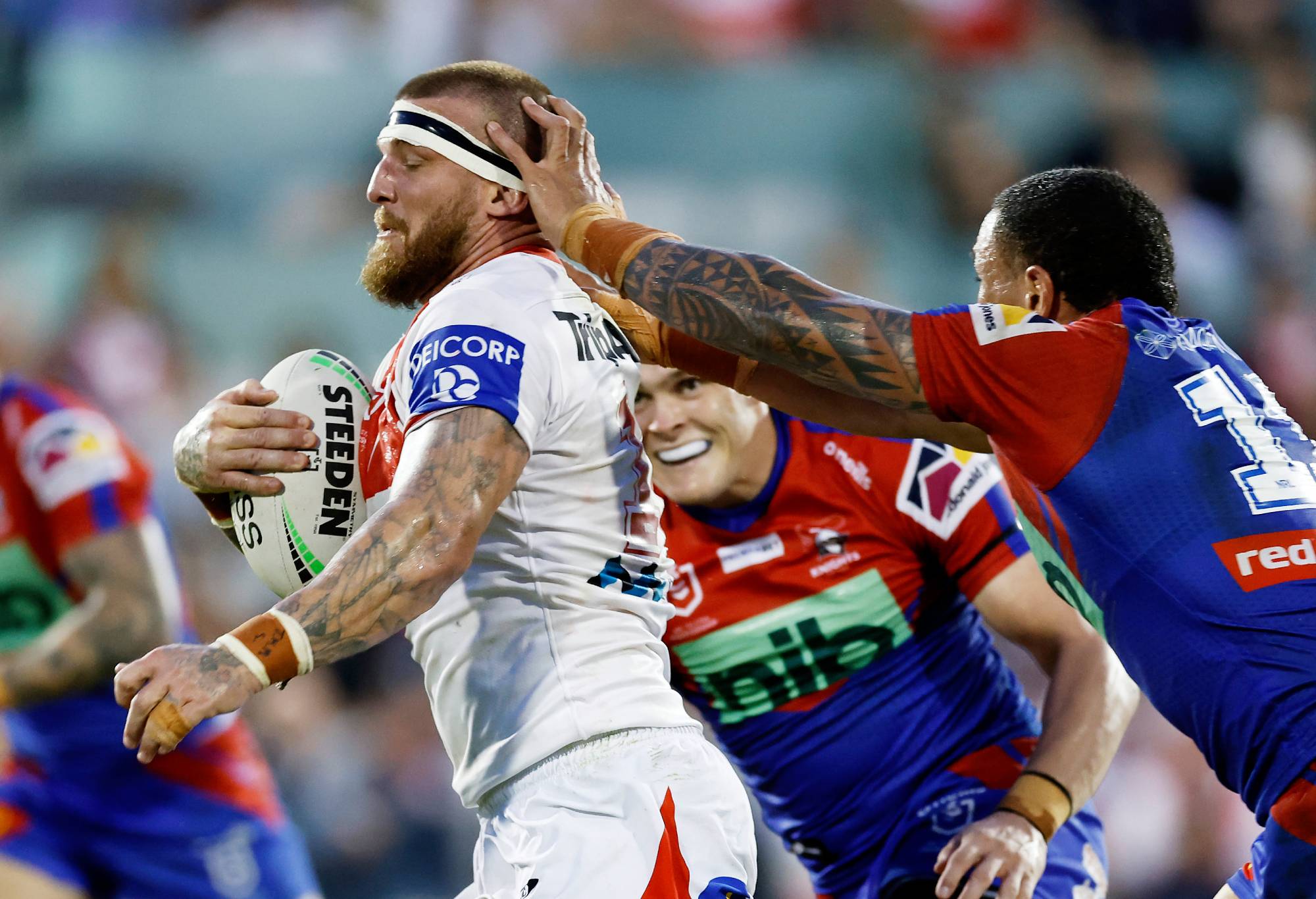 WOLLONGONG, AUSTRALIA - APRIL 17: Josh McGuire of the Dragons avoids the tackle of Tyson Frizell of the Knights during the round six NRL match between the St George Illawarra Dragons and the Newcastle Knights at WIN Stadium, on April 17, 2022, in Wollongong, Australia. (Photo by Mark Evans/Getty Images)