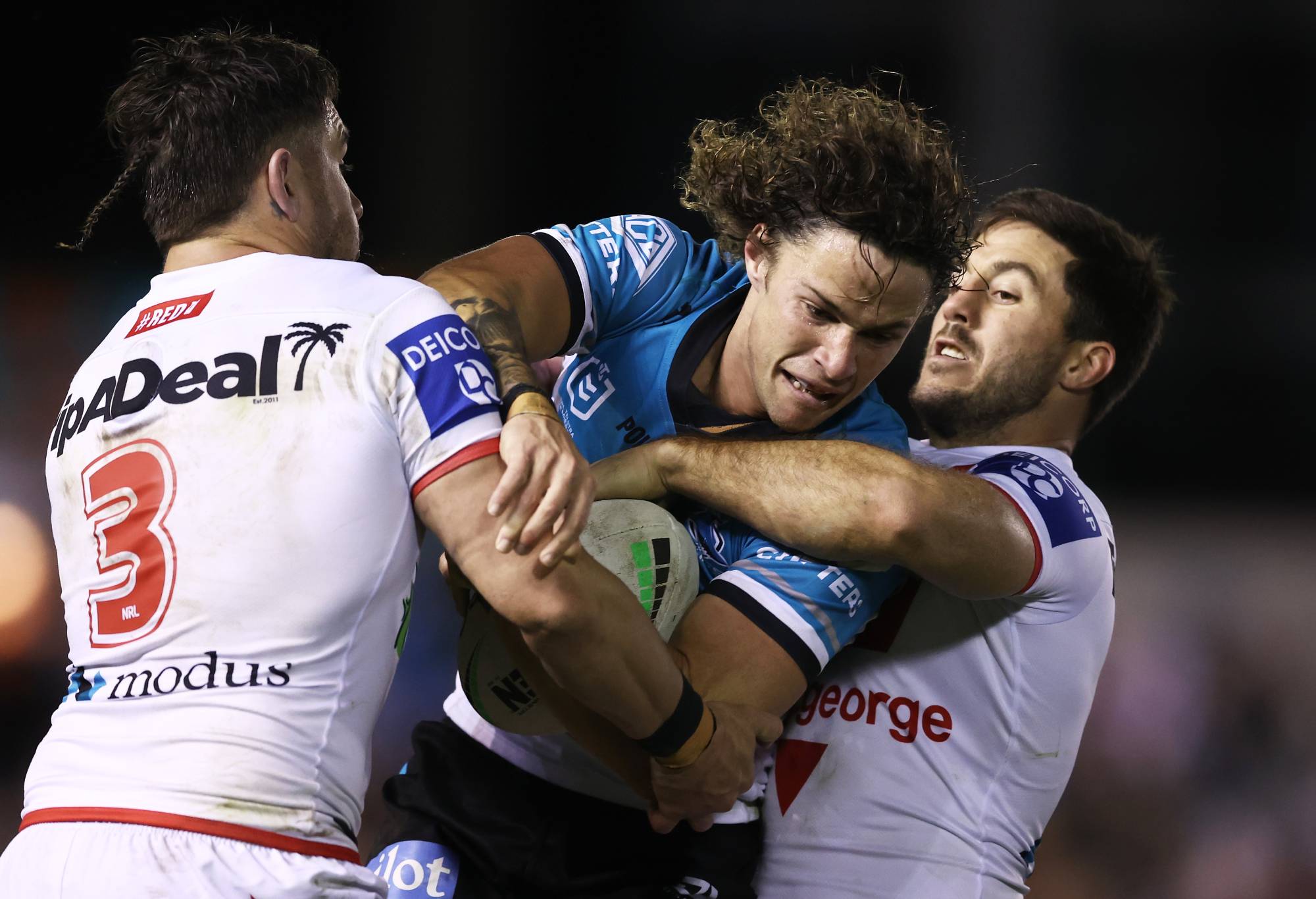 SYDNEY, AUSTRALIA - AUGUST 06: Nicho Hynes of the Sharks is tackled during the round 21 NRL match between the Cronulla Sharks and the St George Illawarra Dragons at PointsBet Stadium, on August 06, 2022, in Sydney, Australia. (Photo by Matt King/Getty Images)