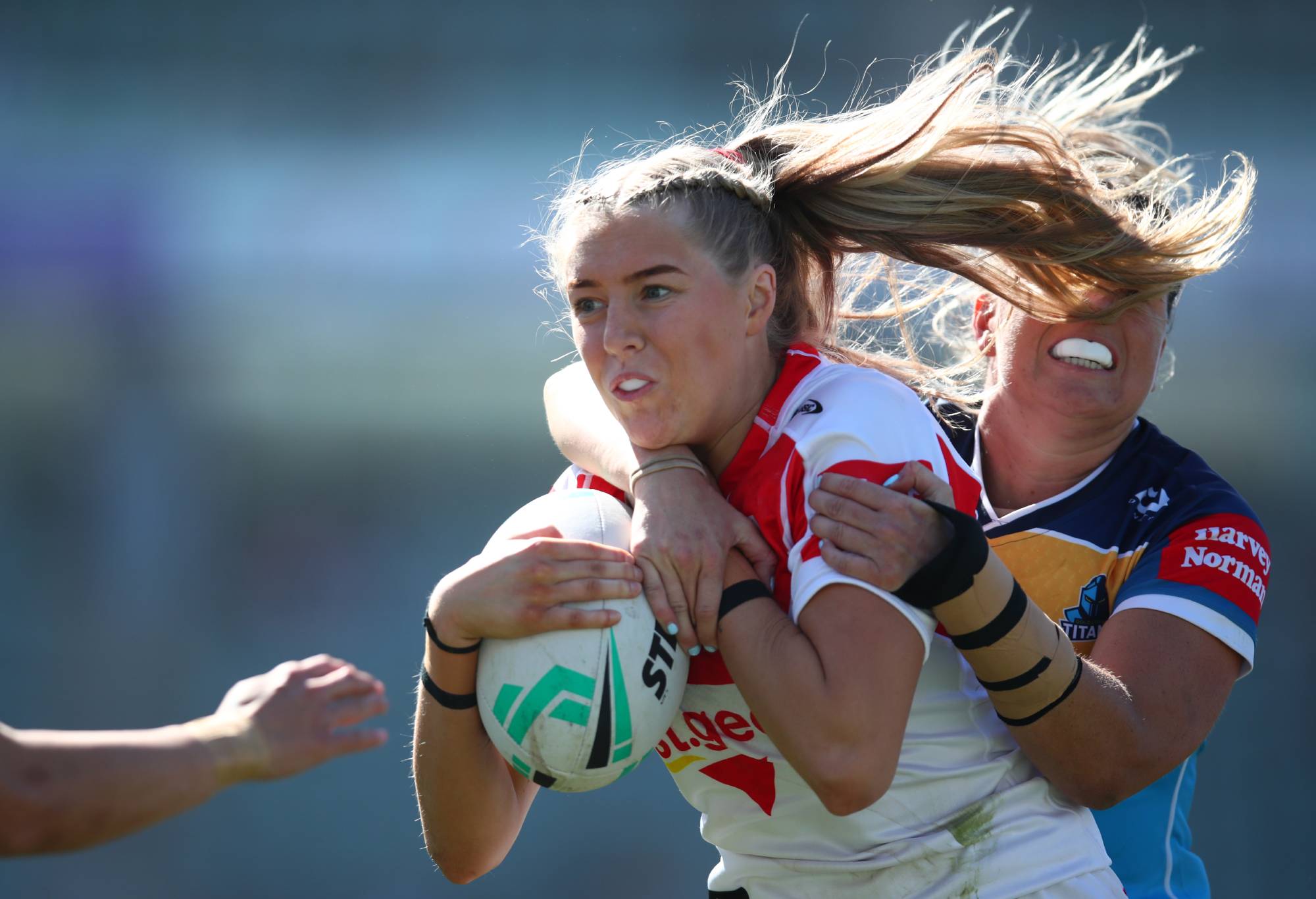 WOLLONGONG, AUSTRALIA - AUGUST 21: Teagan Berry of the Dragons is tackled during the round one NRLW match between St George Illawarra Dragons and Gold Coast Titans at WIN Stadium on August 21, 2022 in Wollongong, Australia. (Photo by Jason McCawley/Getty Images)