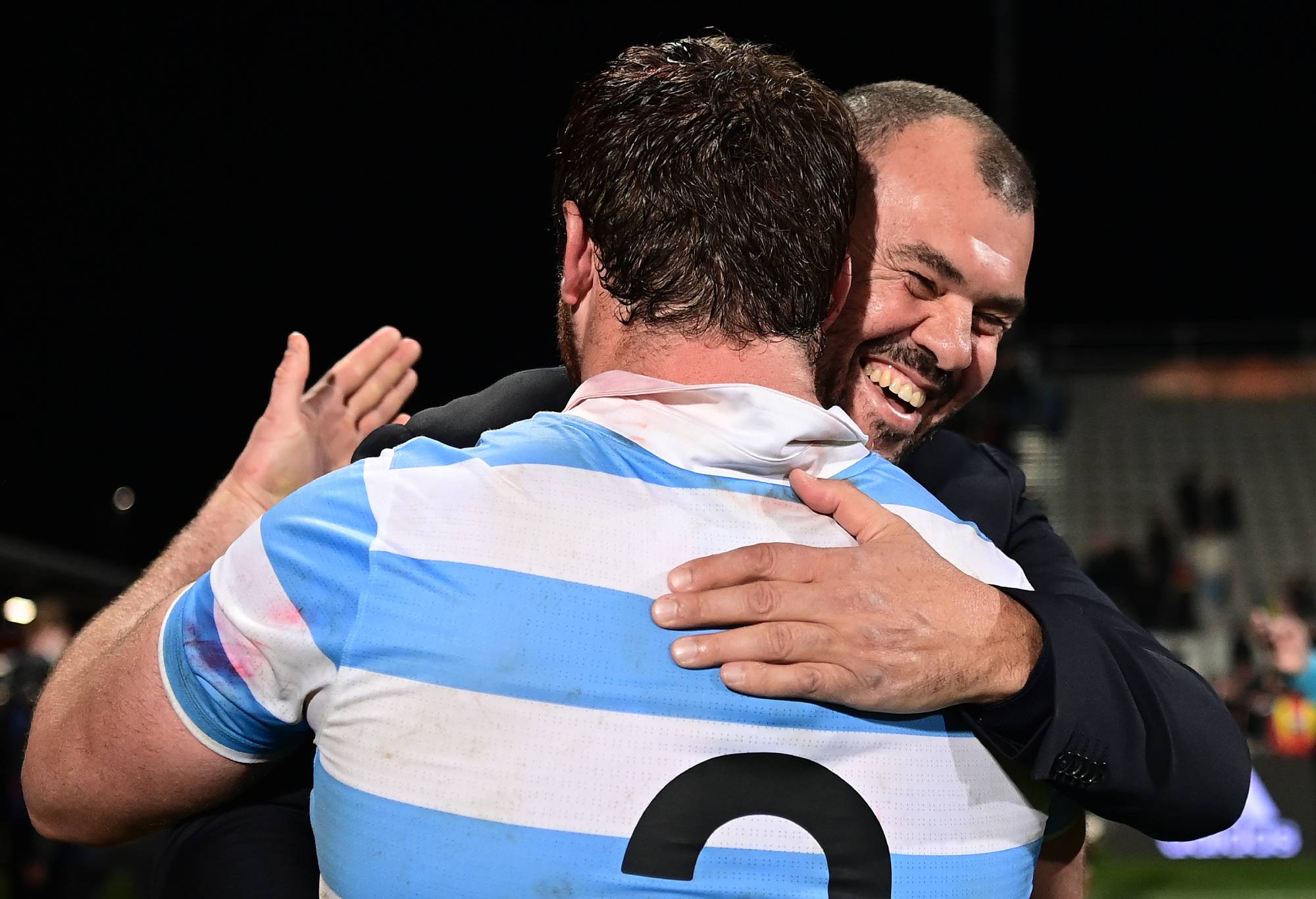 : Pumas head coach Michael Cheika hugs Julian Montoya of the Pumas after winning The Rugby Championship match between the New Zealand All Blacks and Argentina Pumas at Orangetheory Stadium on August 27, 2022 in Christchurch, New Zealand. (Photo by Hannah Peters/Getty Images