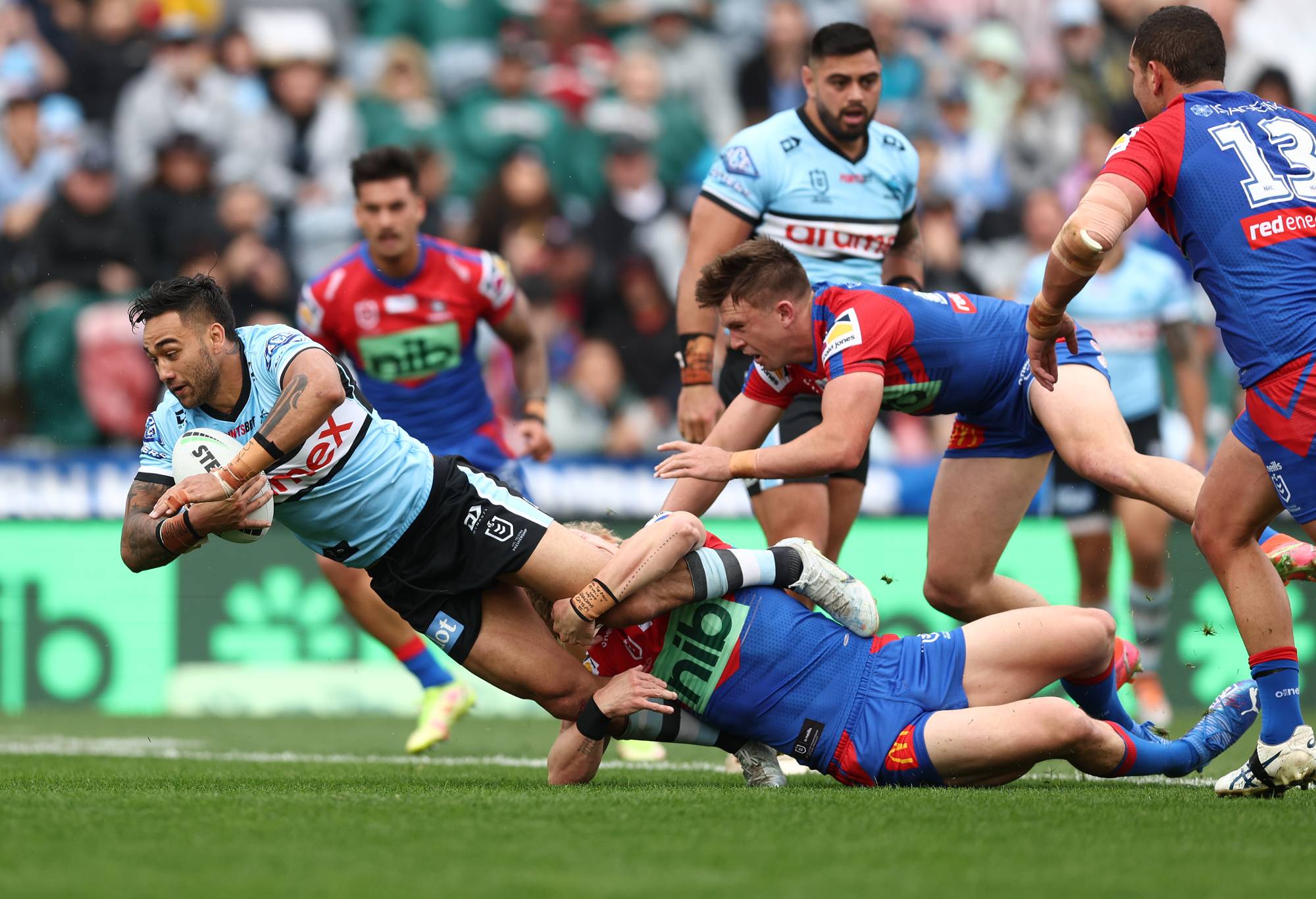 NEWCASTLE, AUSTRALIA - SEPTEMBER 04: Briton Nikora of the Sharks is tackled during the round 25 NRL match between the Newcastle Knights and the Cronulla Sharks at McDonald Jones Stadium, on September 04, 2022, in Newcastle, Australia. (Photo by Mark Metcalfe/Getty Images)
