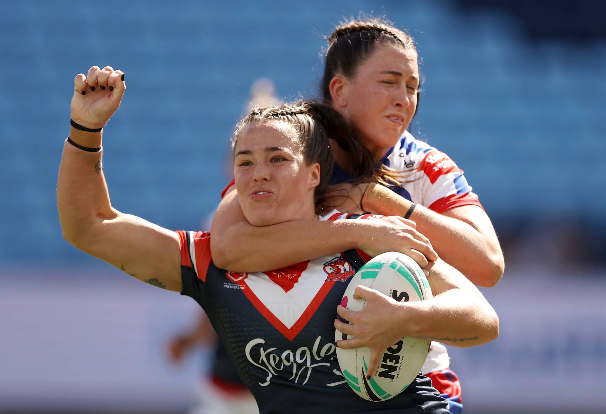 SYDNEY, AUSTRALIA - SEPTEMBER 11: Isabelle Kelly of the Roosters is tackled by Romy Teitzel of the Knights during the round four NRLW match between Newcastle Knights and Sydney Roosters at Allianz Stadium, on September 11, 2022, in Sydney, Australia. (Photo by Mark Kolbe/Getty Images)