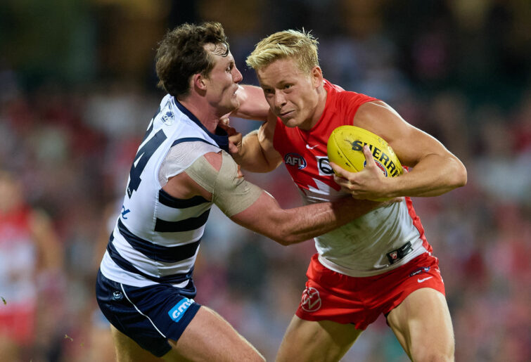 Isaac Heeney is tackled by Jed Bews.