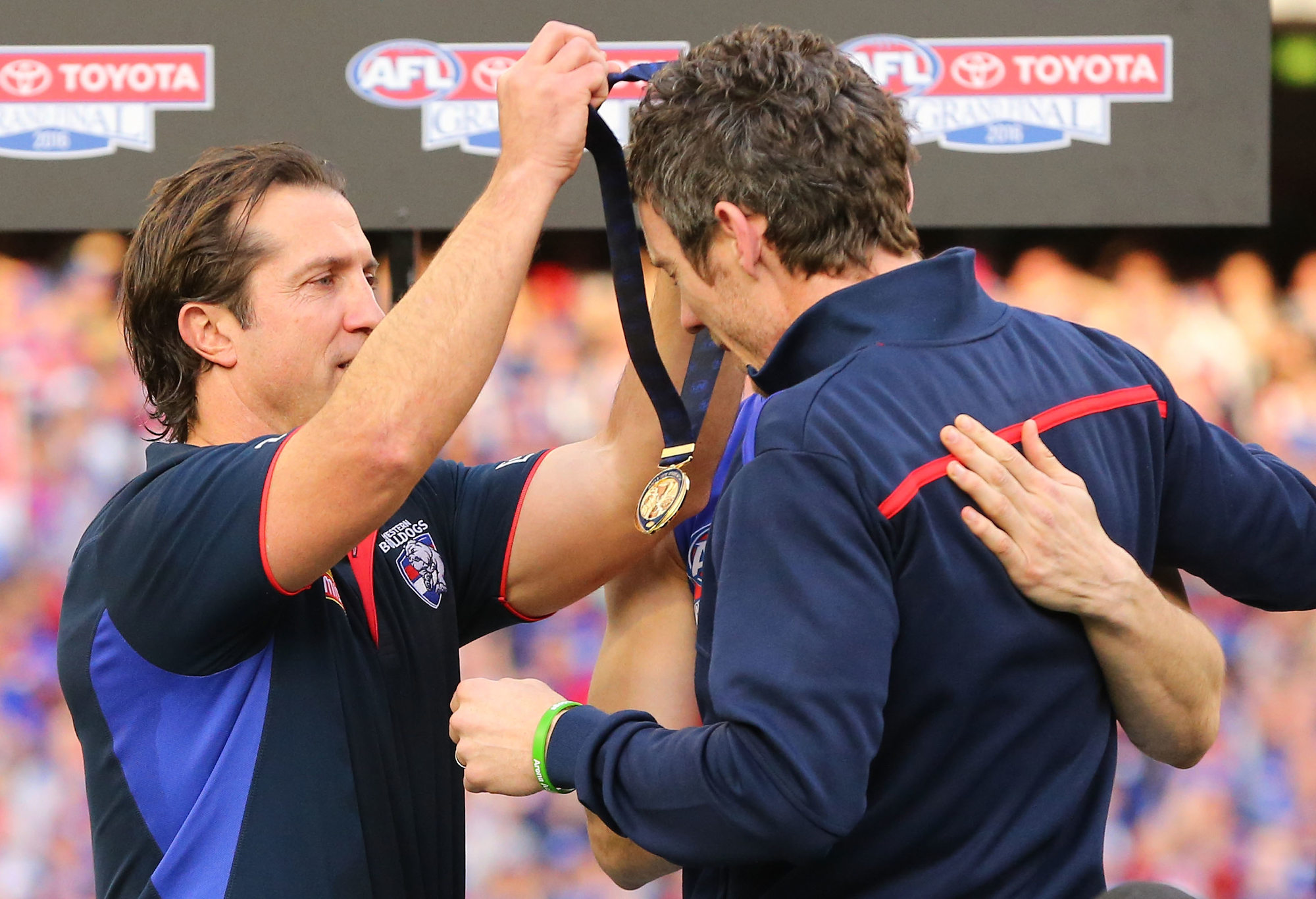 Bulldogs head coach Luke Beveridge gives his medal to the injured Robert Murphy during the 2016 AFL Grand Final.