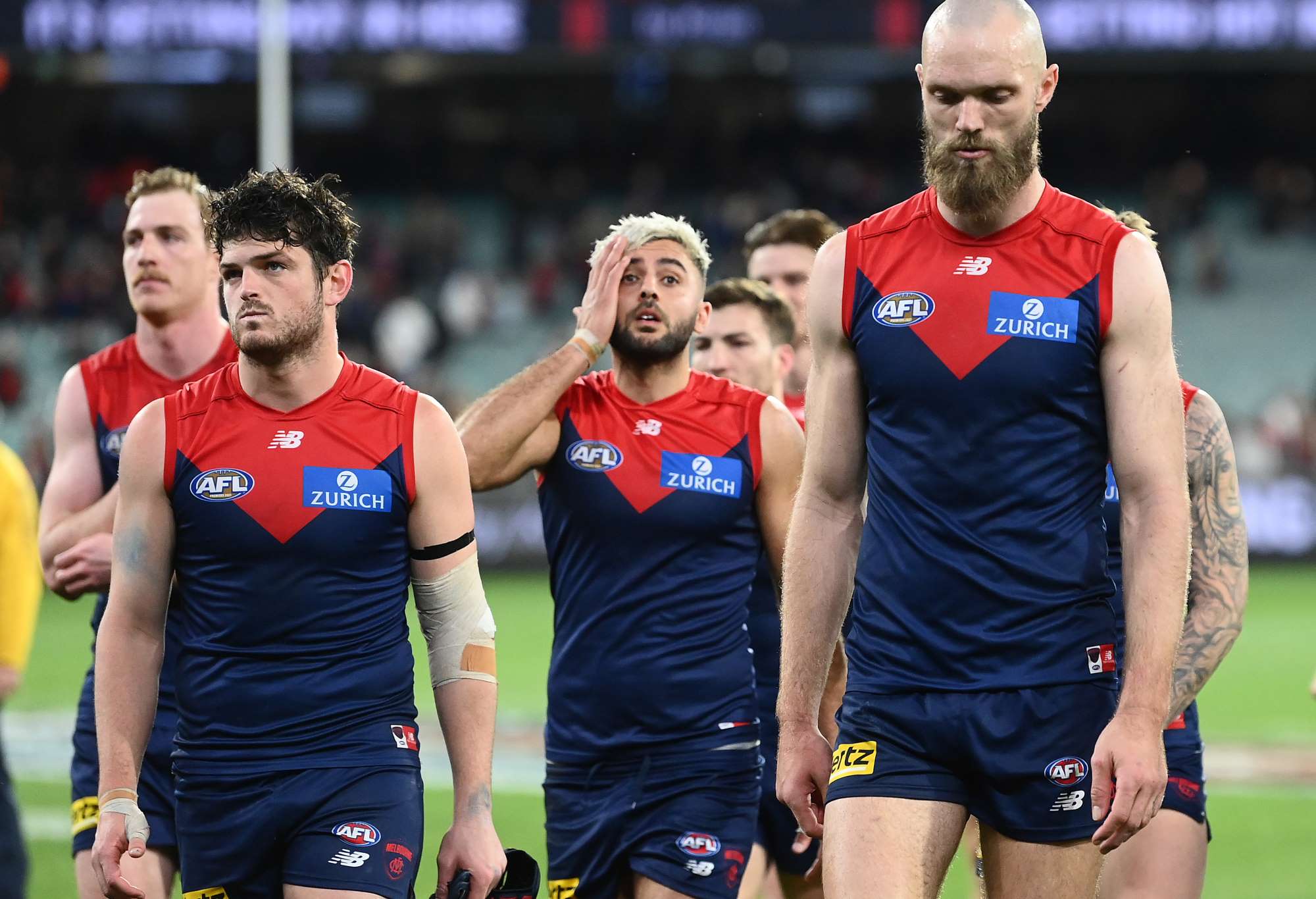 Angus Brayshaw, Christian Salem and Max Gawn of the Demons look dejected after losing
