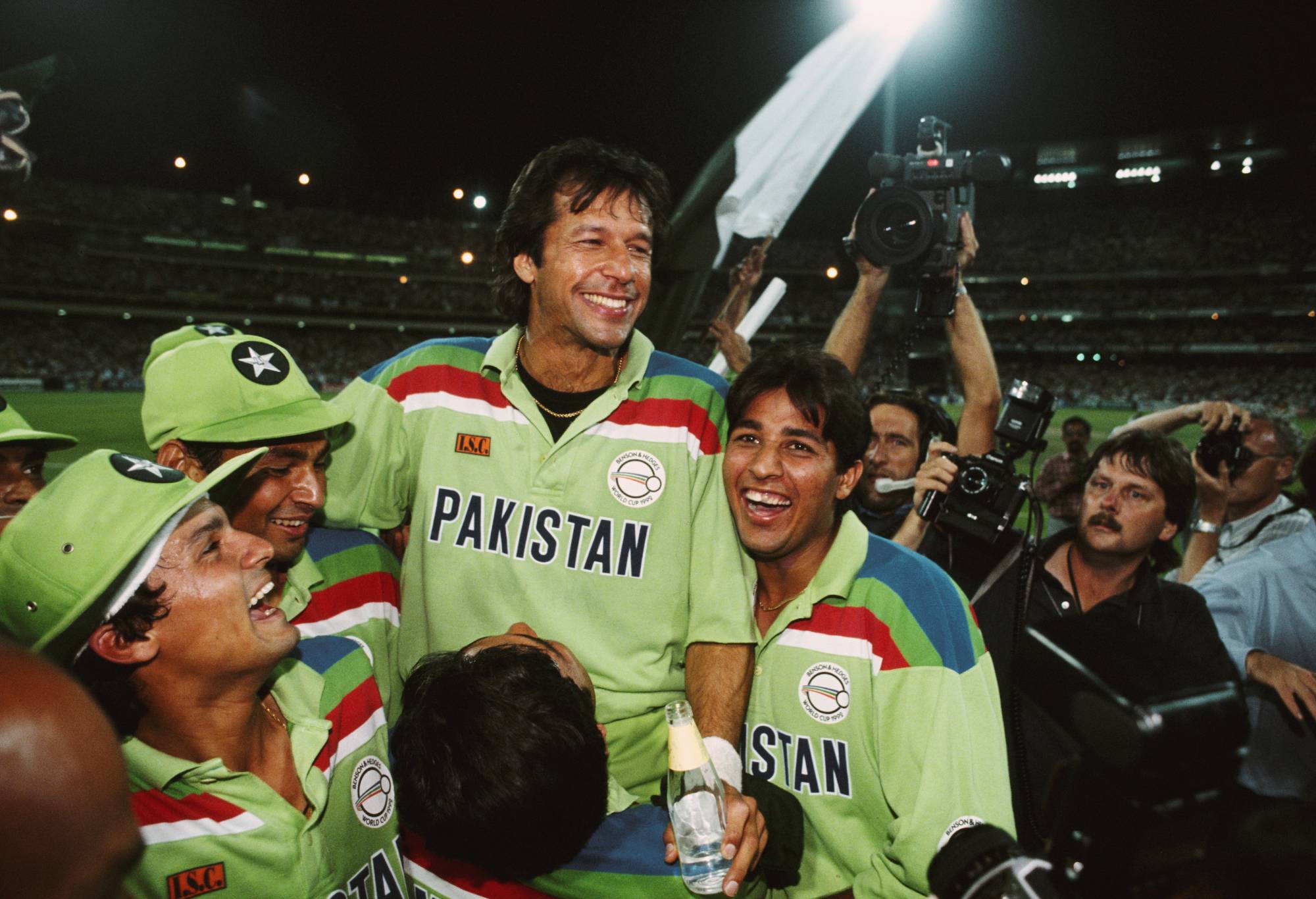 MELBOURNE, AUSTRALIA - MARCH 25: Pakistan captain Imran Khan (c) celebrates with team mates as photographer David Munden (r) looks on after the 1992 Cricket World Cup Final victory against England at MCG on March 25, 1992 in Melbourne, England. (Photo Tony Feder/Allsport/Getty Images)