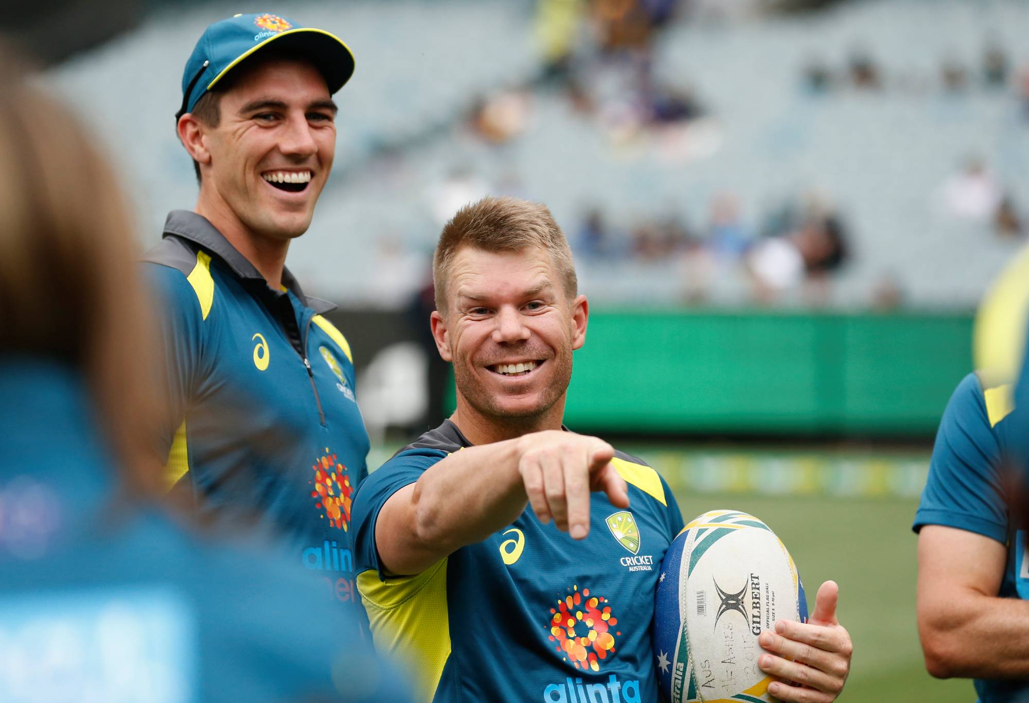 MELBOURNE, AUSTRALIA - NOVEMBER 01: Pat Cummins and David Warner of Australia laugh during the warm up before game three of the Men's International Twenty20 match between Australia and Sri Lanka at Melbourne Cricket Ground on November 01, 2019 in Melbourne, Australia. (Photo by Darrian Traynor/Getty Images)