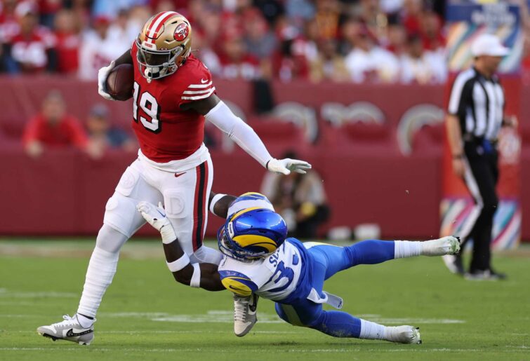 Wide receiver Deebo Samuel #19 of the San Francisco 49ers is tackled by safety Nick Scott #33 of the Los Angeles Rams during the second quarter at Levi's Stadium on October 03, 2022 in Santa Clara, California. (Photo by Ezra Shaw/Getty Images)