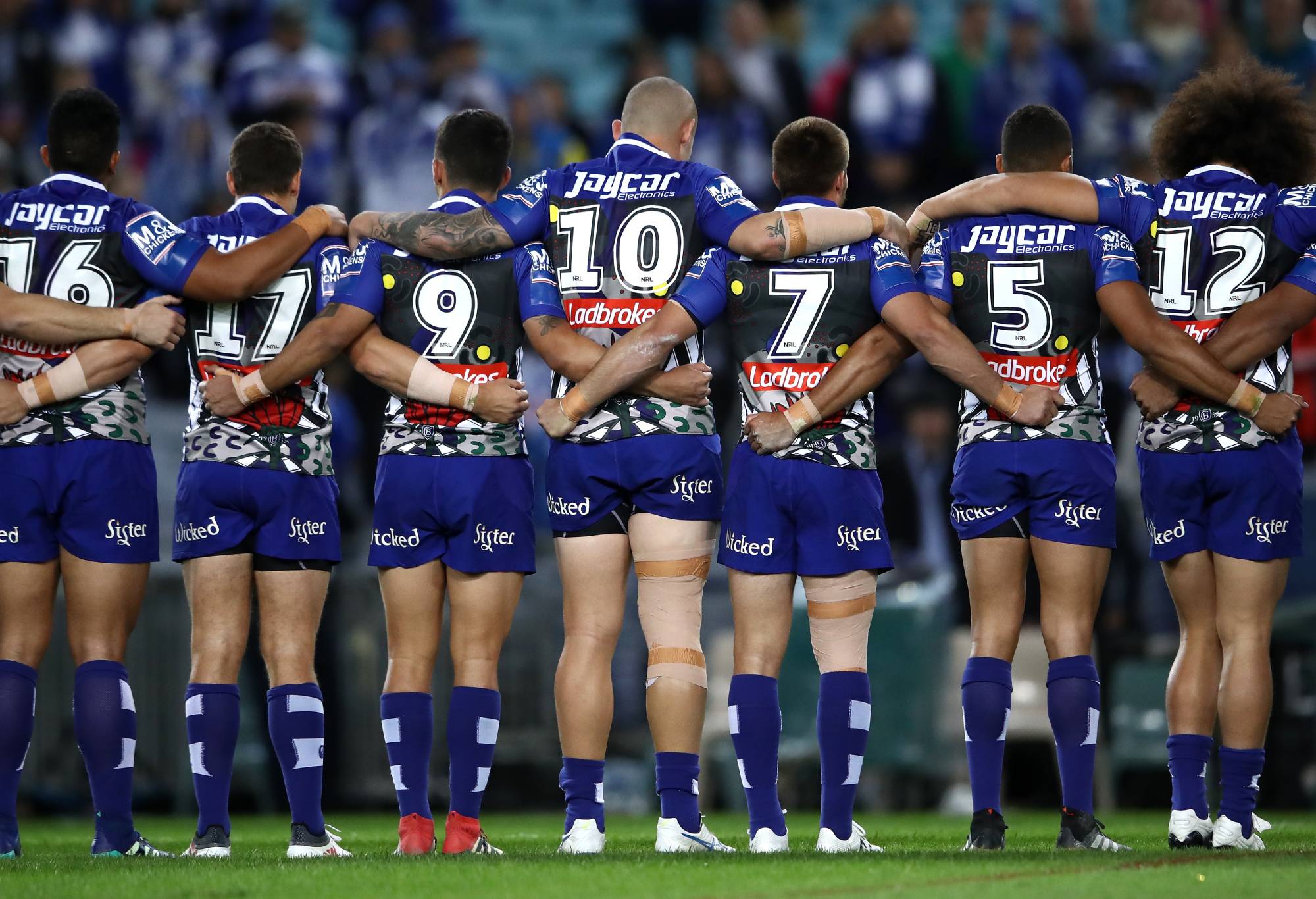 SYDNEY, AUSTRALIA - MAY 11: Bulldogs players line up for the national anthem during the round 10 NRL match between the Canterbury Bulldogs and the Parramatta Eels at ANZ Stadium on May 11, 2018 in Sydney, Australia. (Photo by Cameron Spencer/Getty Images)