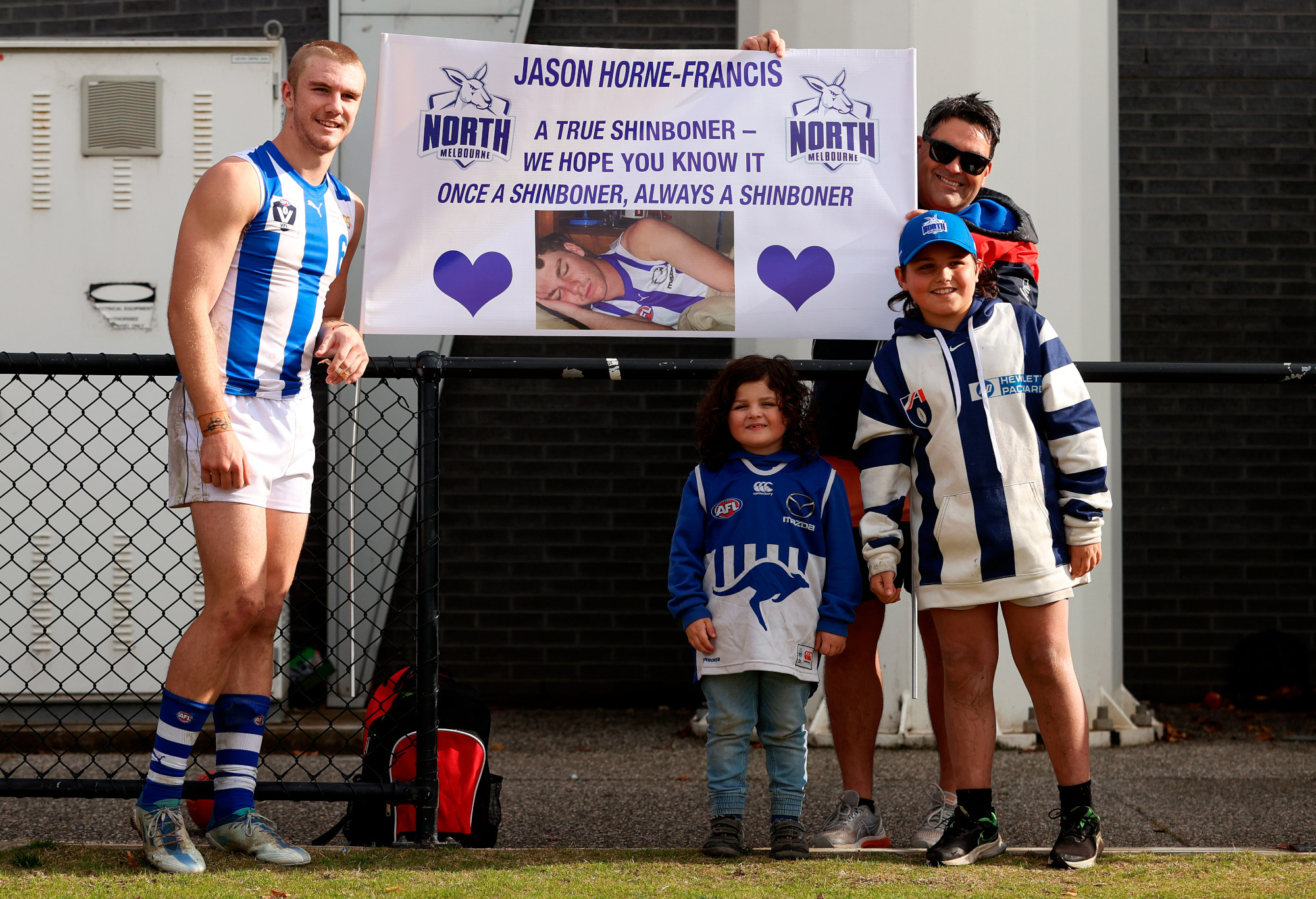 Jason Horne-Francis poses for a photo with North Melbourne supporters.
