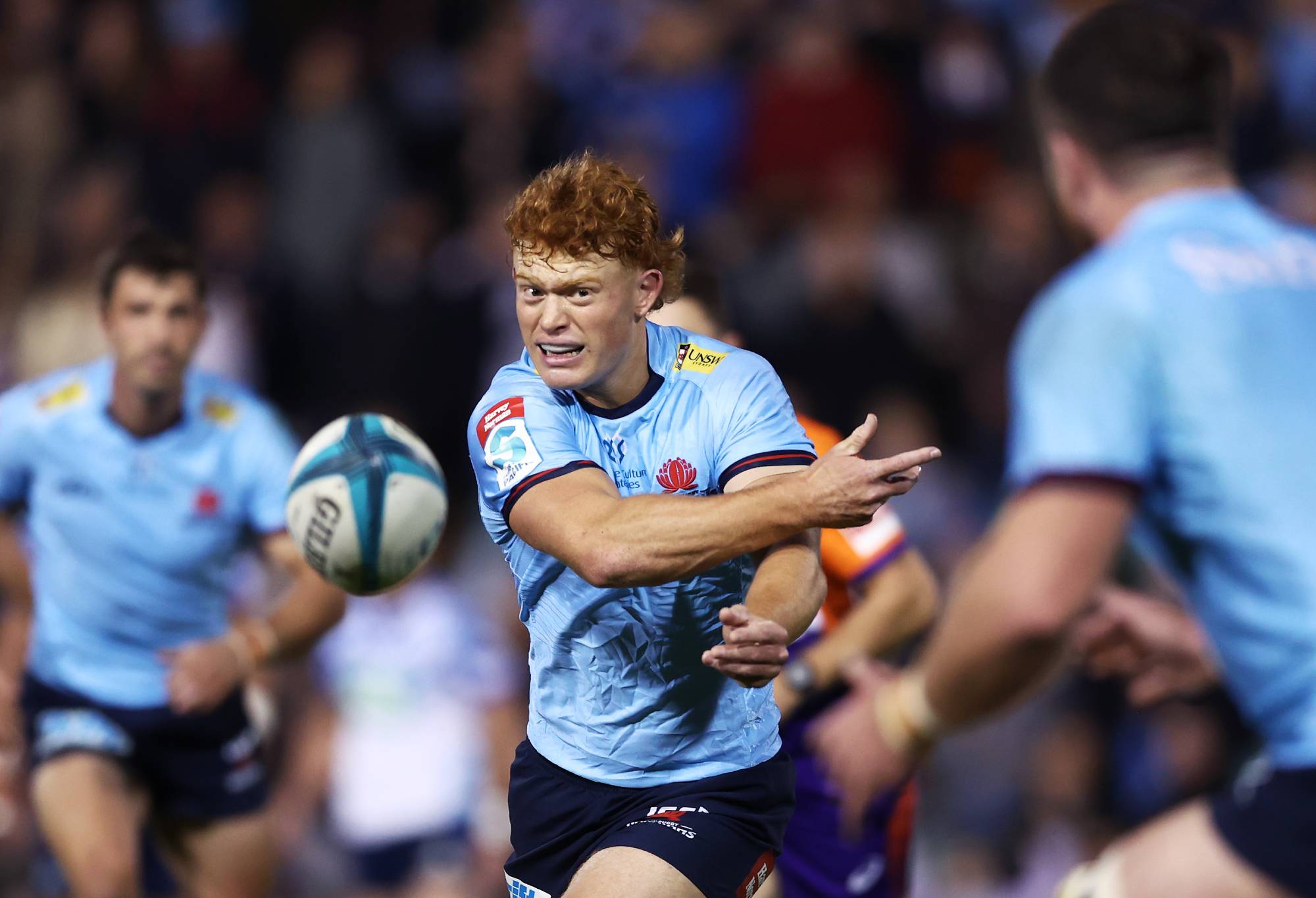 Tane Edmed of the Waratahs passes during the round 15 Super Rugby Pacific match between the NSW Waratahs and the Blues at Leichhardt Oval on May 28, 2022 in Sydney, Australia. (Photo by Matt King/Getty Images)