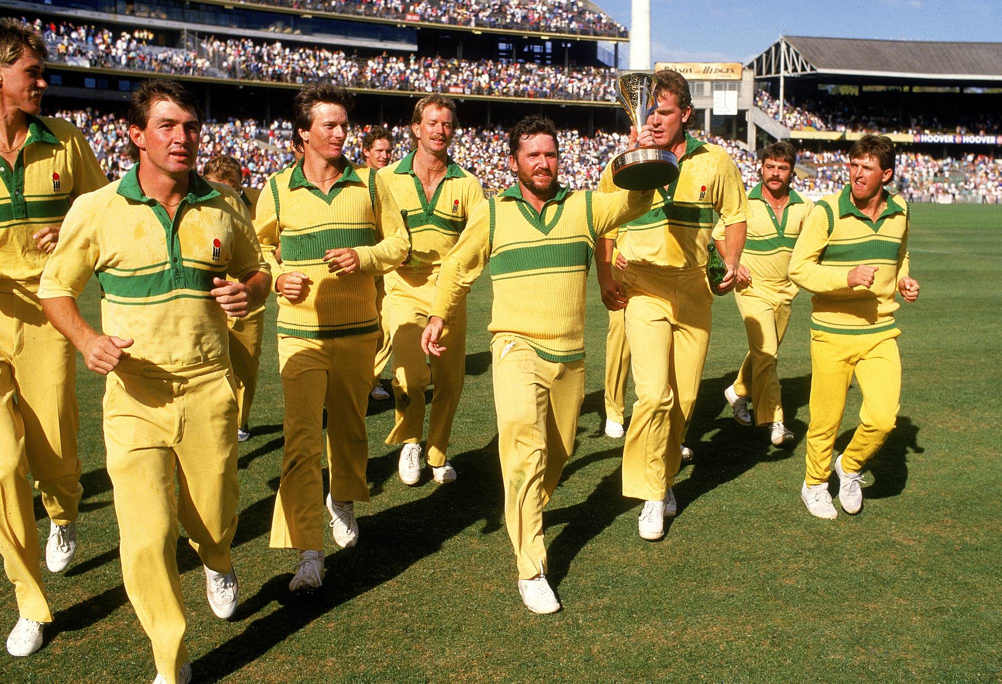 MELBOURNE, AUSTRALIA - FEBRUARY 9: Allan Border (C) of Australia holds aloft the world series cup after the Benson & Hedges World Series Cup 2nd final match between Australia and India at the Melbourne Cricket Ground February 9, 1986 in Melbourne, Australia. (Photo by Tony Feder/Getty Images)