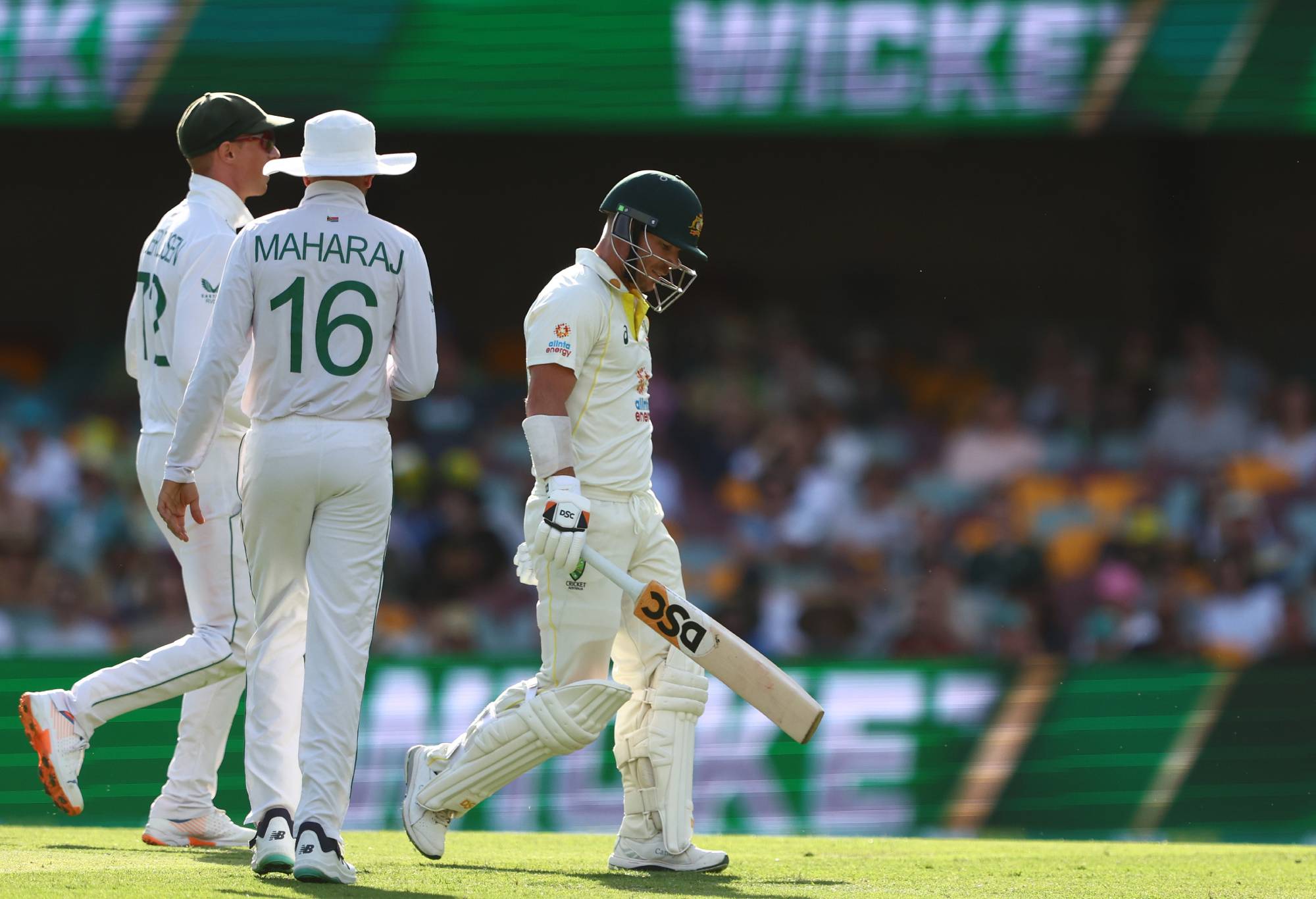 BRISBANE, AUSTRALIA - DECEMBER 18: David Warner of Australia is seen walking from the field after losing his wicket to Kagiso Rabada of South Africa during day two of the First Test match between Australia and South Africa at The Gabba on December 18, 2022 in Brisbane, Australia. (Photo by Chris Hyde - CA/Cricket Australia via Getty Images)