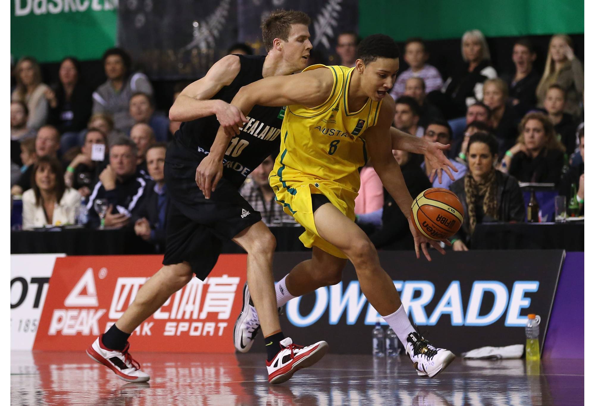 AUCKLAND, NEW ZEALAND - AUGUST 14: Tom Abercrombie of New Zealand (L) and Ben Simmons of Australia in action during the Men's FIBA Oceania Championship match between the New Zealand Tall Blacks and the Australian Boomers at North Shore Events Centre on August 14, 2013 in Auckland, New Zealand. (Photo by Sandra Mu/Getty Images)