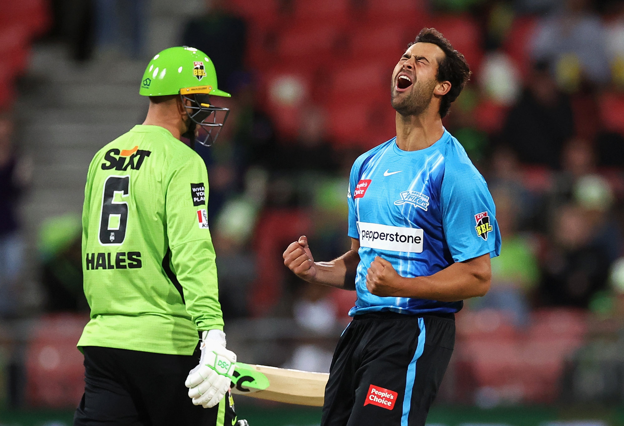 Wes Agar of the Strikers celebrates dismissing Alex Hales of the Thunder.