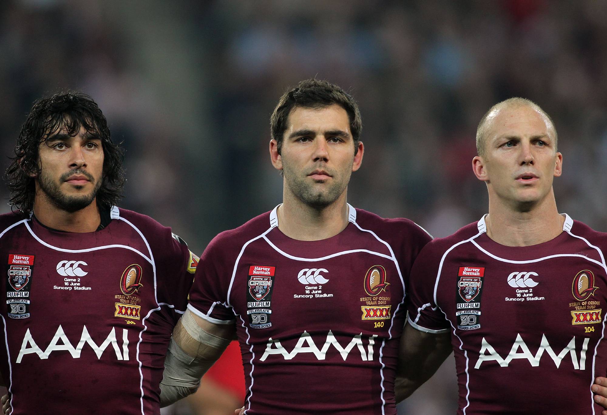 BRISBANE, AUSTRALIA - JUNE 16: (L-R) Johnathan Thurston, Cameron Smith and Darren Lockyer embrace during the national anthem before game two of the ARL State of Origin Series between the New South Wales Blues and the Queensland Maroons at Suncorp Stadium on June 16, 2010 in Brisbane, Australia. (Photo by Bradley Kanaris/Getty Images)