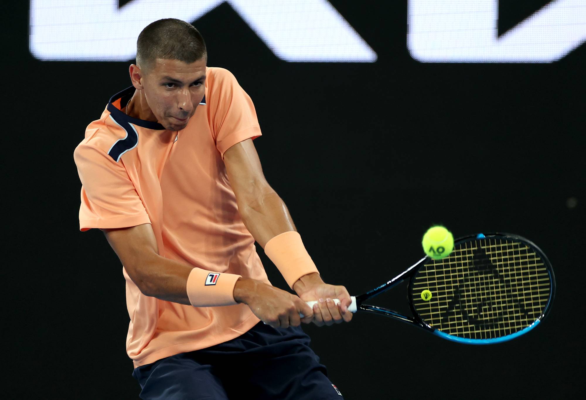 MELBOURNE, AUSTRALIA - JANUARY 17: Alexei Popyrin of Australia plays a backhand in their round one singles match against Chun-Hsin Tseng of Taiwan during day two of the 2023 Australian Open at Melbourne Park on January 17, 2023 in Melbourne, Australia. (Photo by Mackenzie Sweetnam/Getty Images)