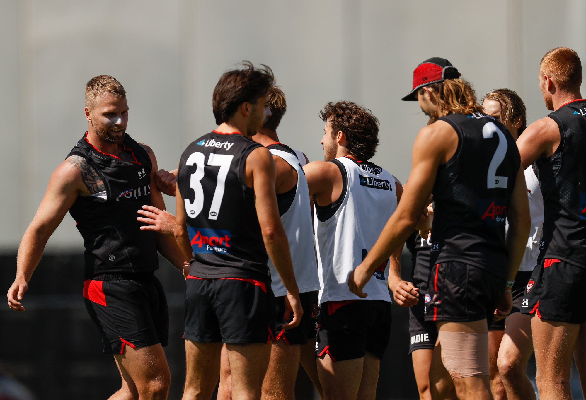 Jake Stringer and teammate Mason Redman of the Bombers are separated by teammates after a clash.
