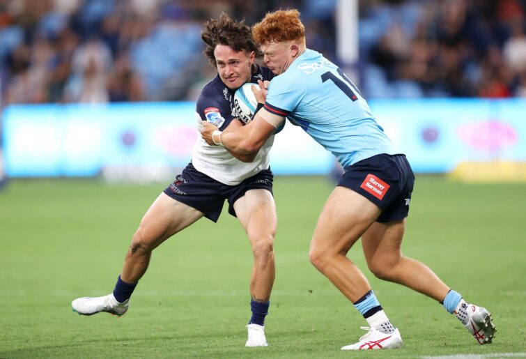 Corey Toole of the Brumbies is tackled by Tane Edmed of the Waratahs during the round one Super Rugby Pacific match between NSW Waratahs and ACT Brumbies at Allianz Stadium, on February 24, 2023, in Sydney, Australia. (Photo by Mark Kolbe/Getty Images)