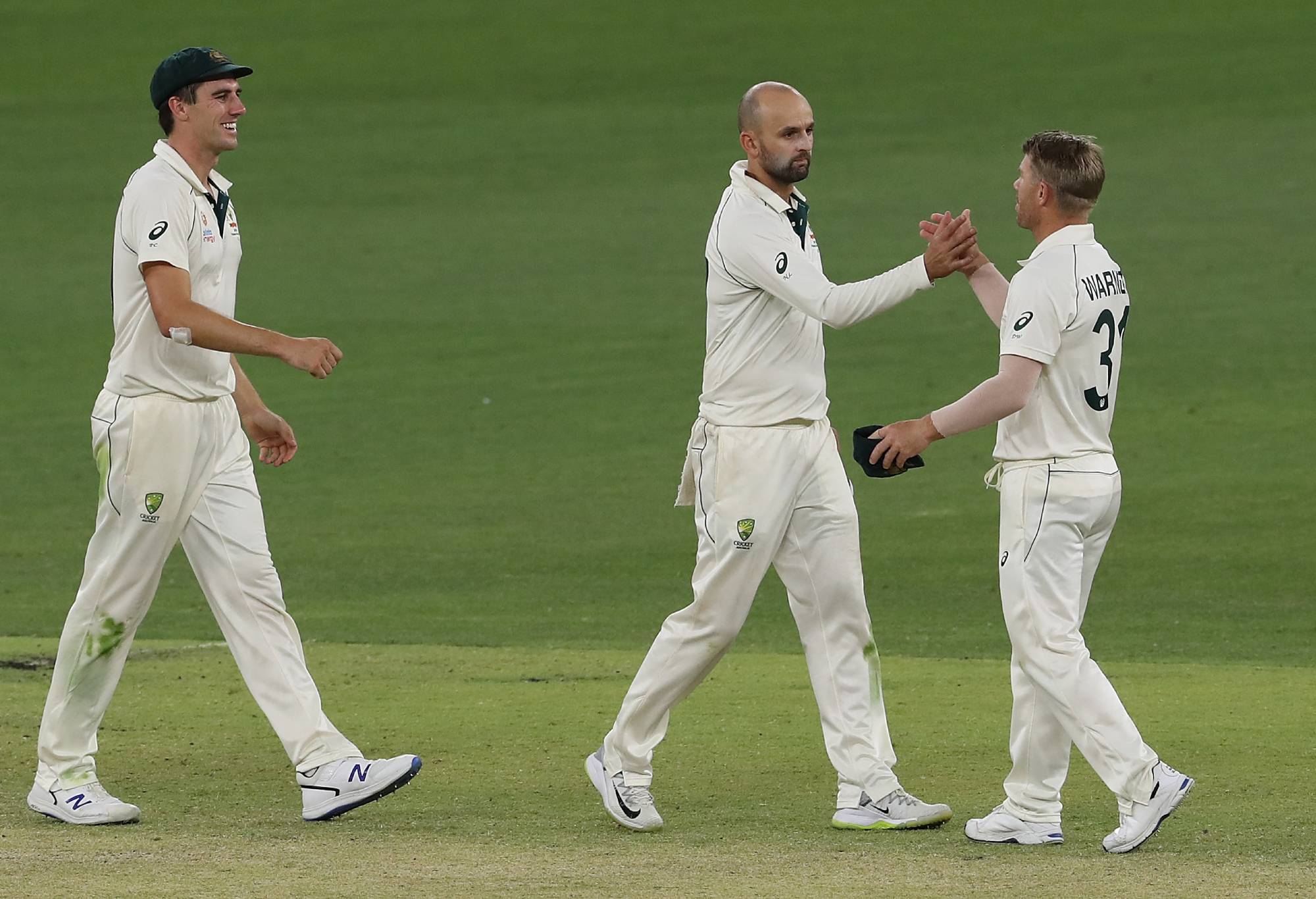 PERTH, AUSTRALIA - DECEMBER 15: Nathan Lyon and David Warner of Australia celebrate winning during day four of the First Test match in the series between Australia and New Zealand at Optus Stadium on December 15, 2019 in Perth, Australia. (Photo by Paul Kane - CA/Cricket Australia via Getty Images)