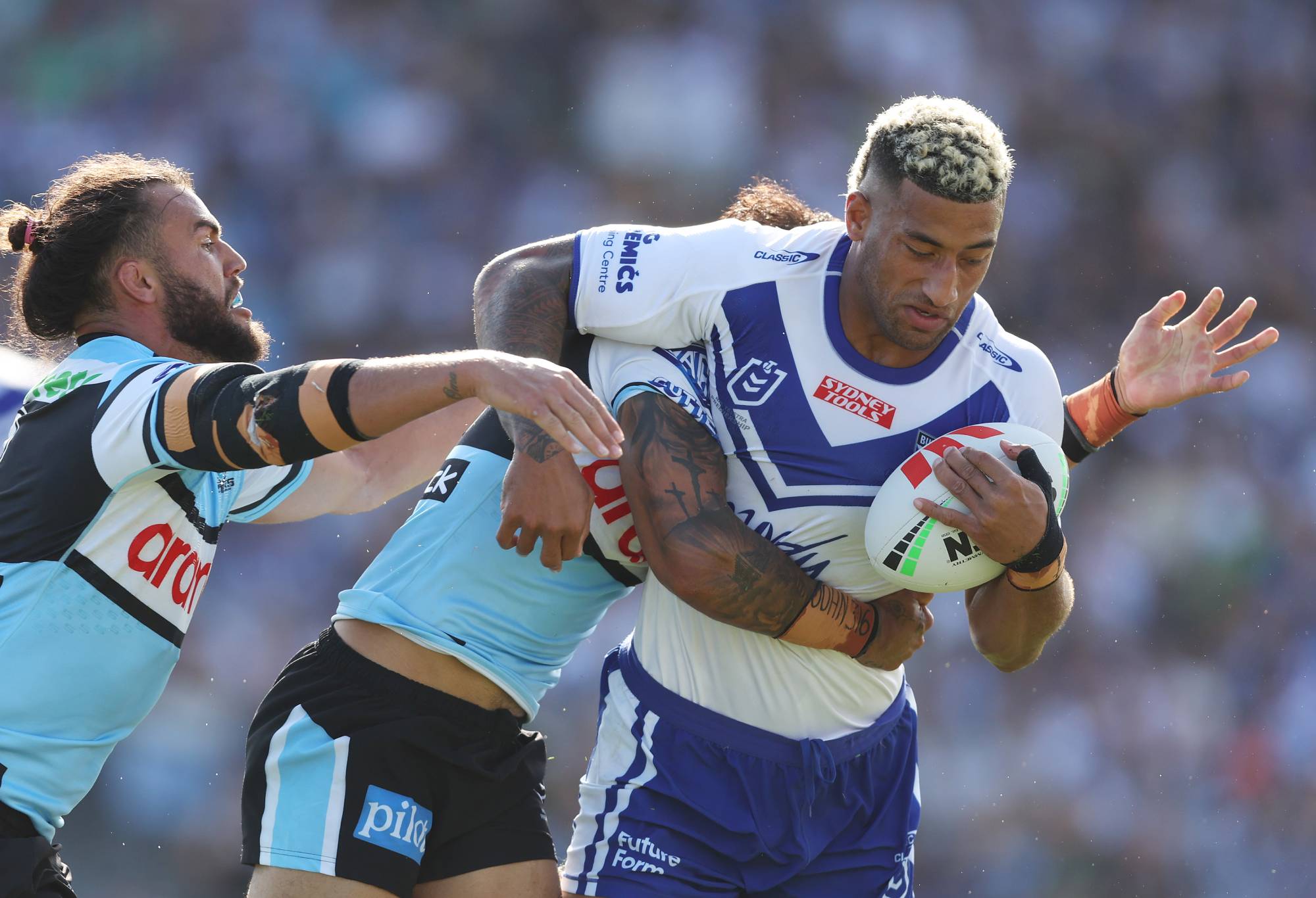 SYDNEY, AUSTRALIA - FEBRUARY 19: Viliame Kikau of the Bulldogs is tackled during the NRL Trial Match between the Canterbury Bulldogs and the Cronulla Sharks at Belmore Sports Ground on February 19, 2023 in Sydney, Australia. (Photo by Mark Metcalfe/Getty Images)