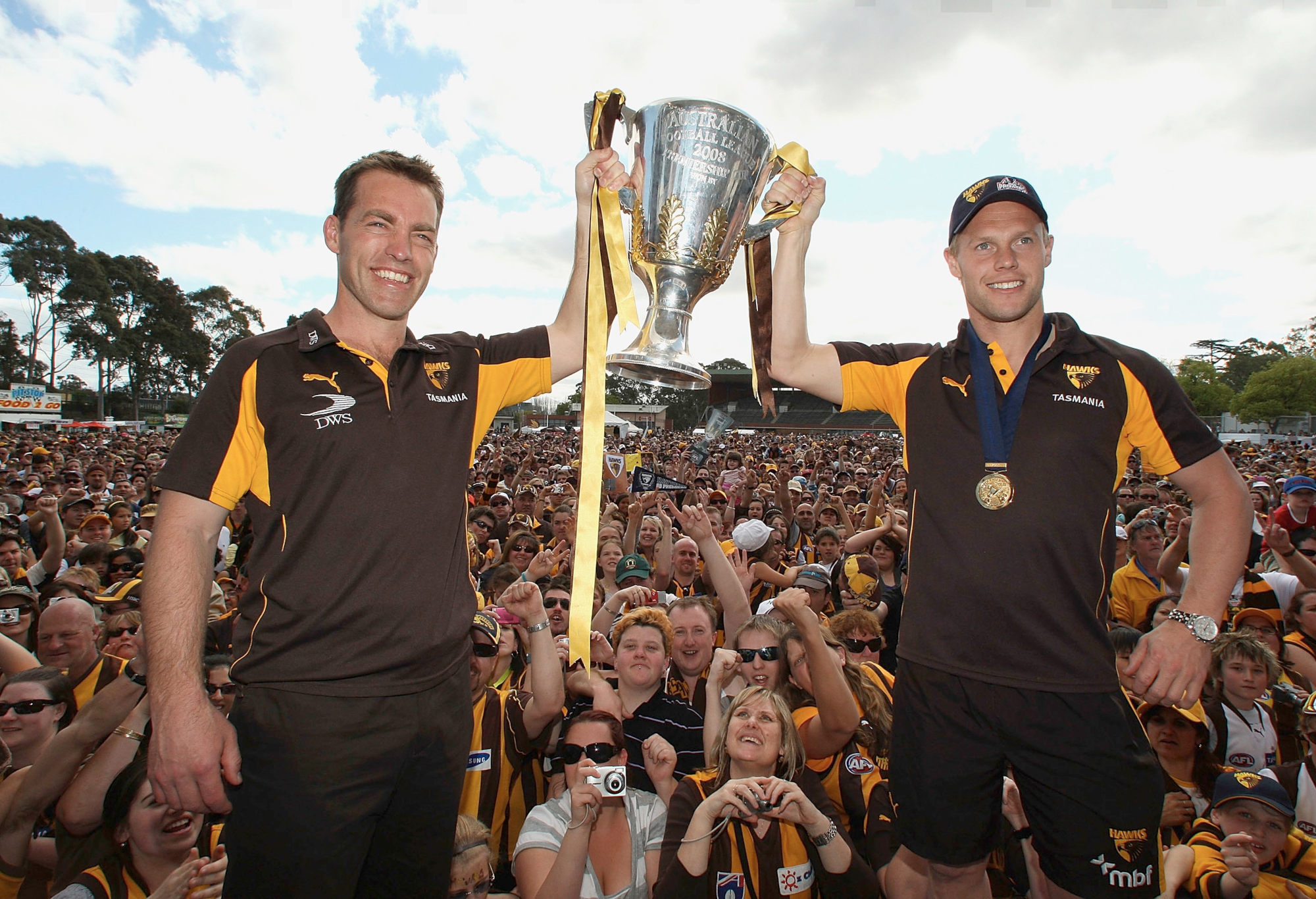 Alastair Clarkson and Sam Mitchell celebrate with the 2008 AFL premiership cup.