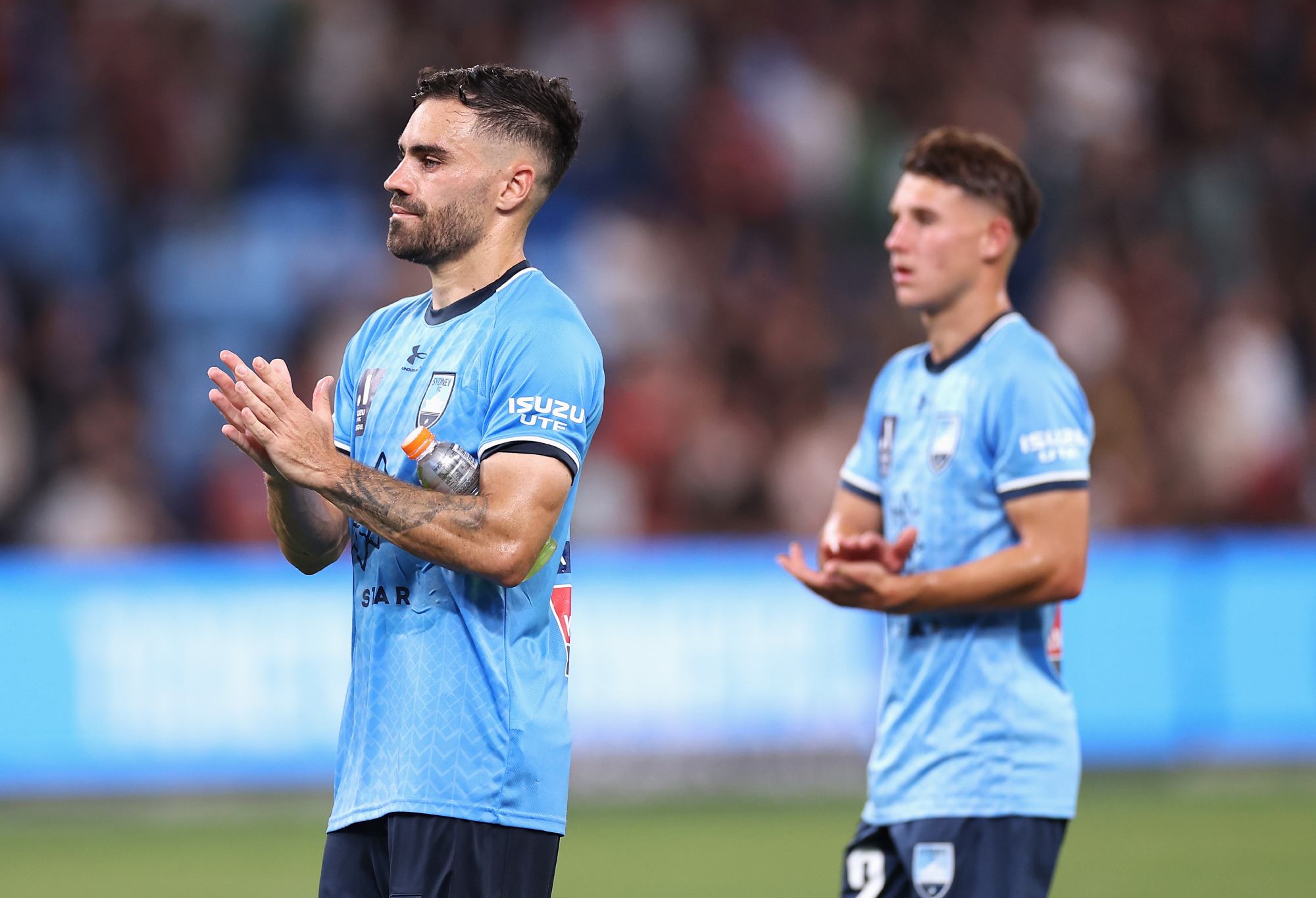 SYDNEY, AUSTRALIA - MARCH 18: Anthony Caceres of Sydney FC and Adrian Segecic of Sydney FC thank fans after losing the round 21 A-League Men's match between Sydney FC and Western Sydney Wanderers at Allianz Stadium, on March 18, 2023, in Sydney, Australia. (Photo by Cameron Spencer/Getty Images)