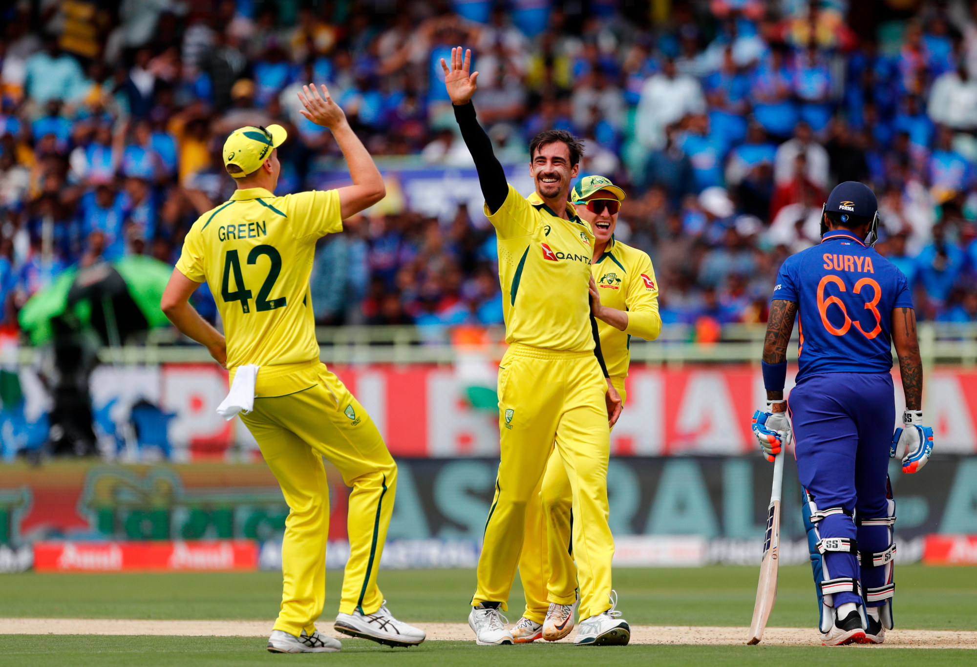 Mitchell Starc of Australia celebrates the wicket of Suryakumar Yadav of India.