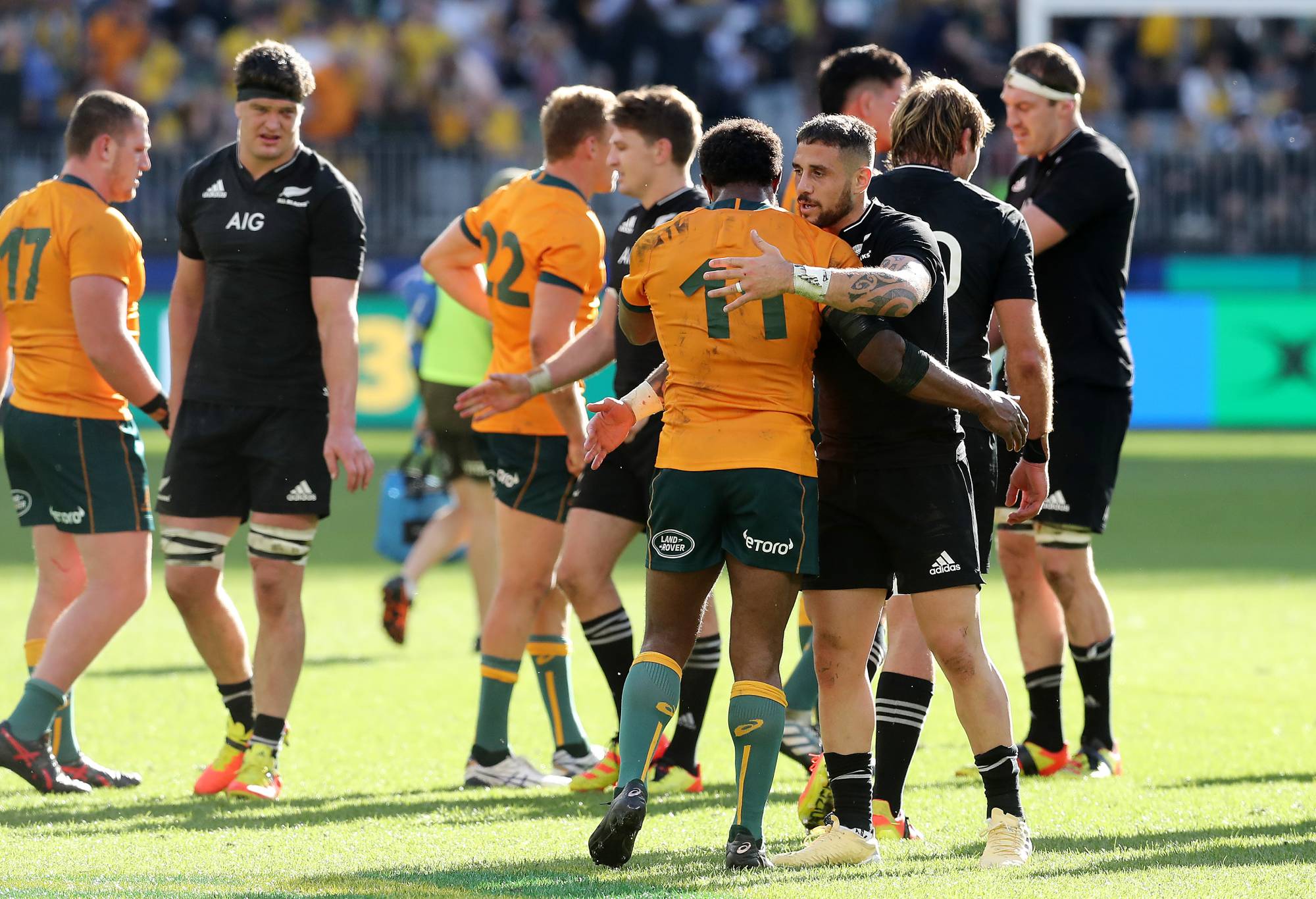 TJ Perenara of the All Blacks and Marika Koroibete of the Wallabies embrace after the Bledisloe Cup match between the Australian Wallabies and the New Zealand All Blacks, part of The Rugby Championship, at Optus Stadium on September 05, 2021 in Perth, Australia. (Photo by Will Russell/Getty Images)