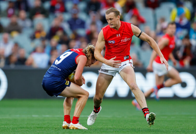 Charlie Spargo of the Demons and Mason Redman of the Bombers compete for the ball.