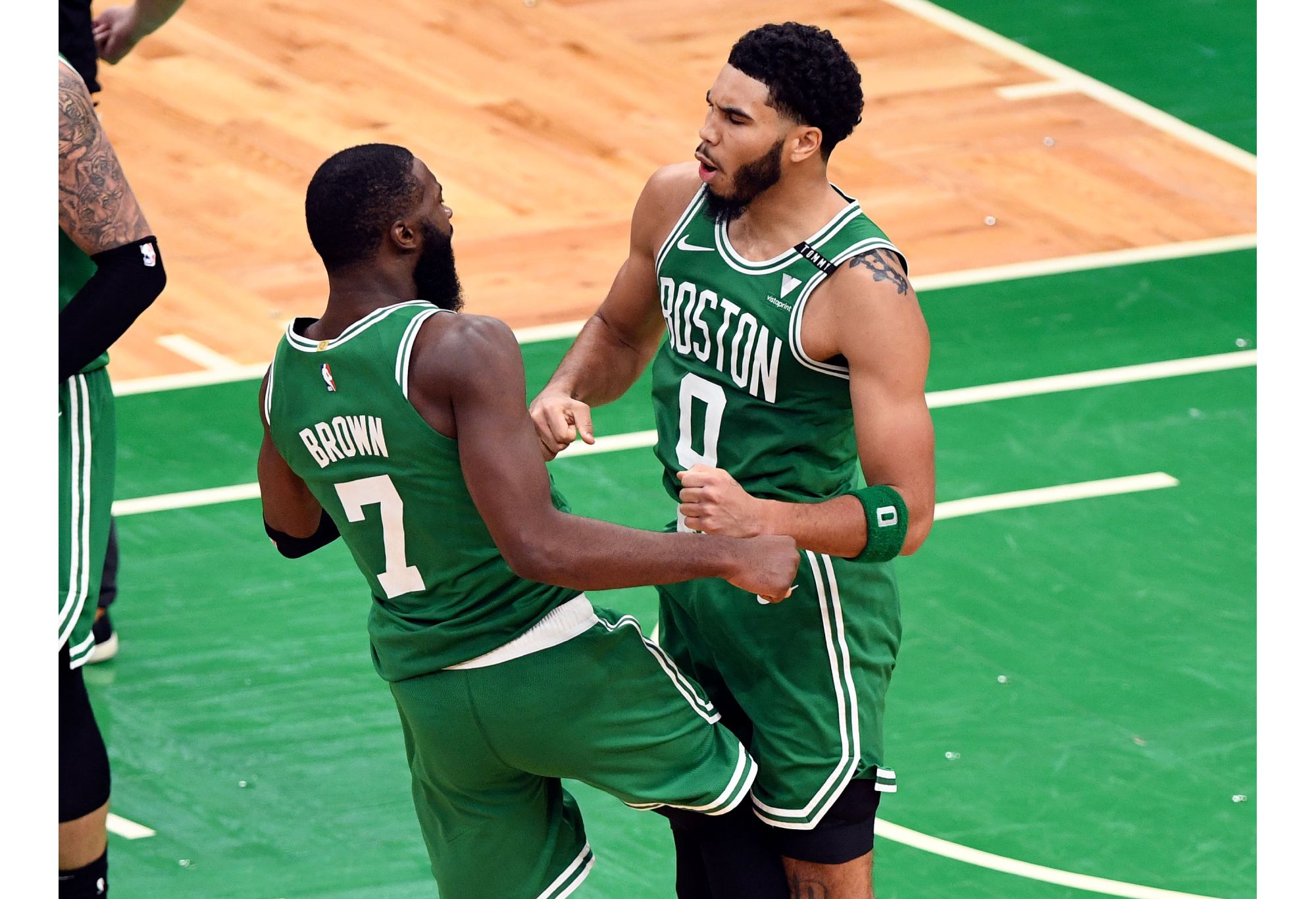 BOSTON, MASSACHUSETTS - DECEMBER 23: Jayson Tatum #0 and Jaylen Brown #7 of the Boston Celtics celebrate after scoring against the Milwaukee Bucks during the second half at TD Garden on December 23, 2020 in Boston, Massachusetts. NOTE TO USER: User expressly acknowledges and agrees that, by downloading and/or using this photograph, user is consenting to the terms and conditions of the Getty Images License Agreement. (Photo by Brian Fluharty-Pool/Getty Images)