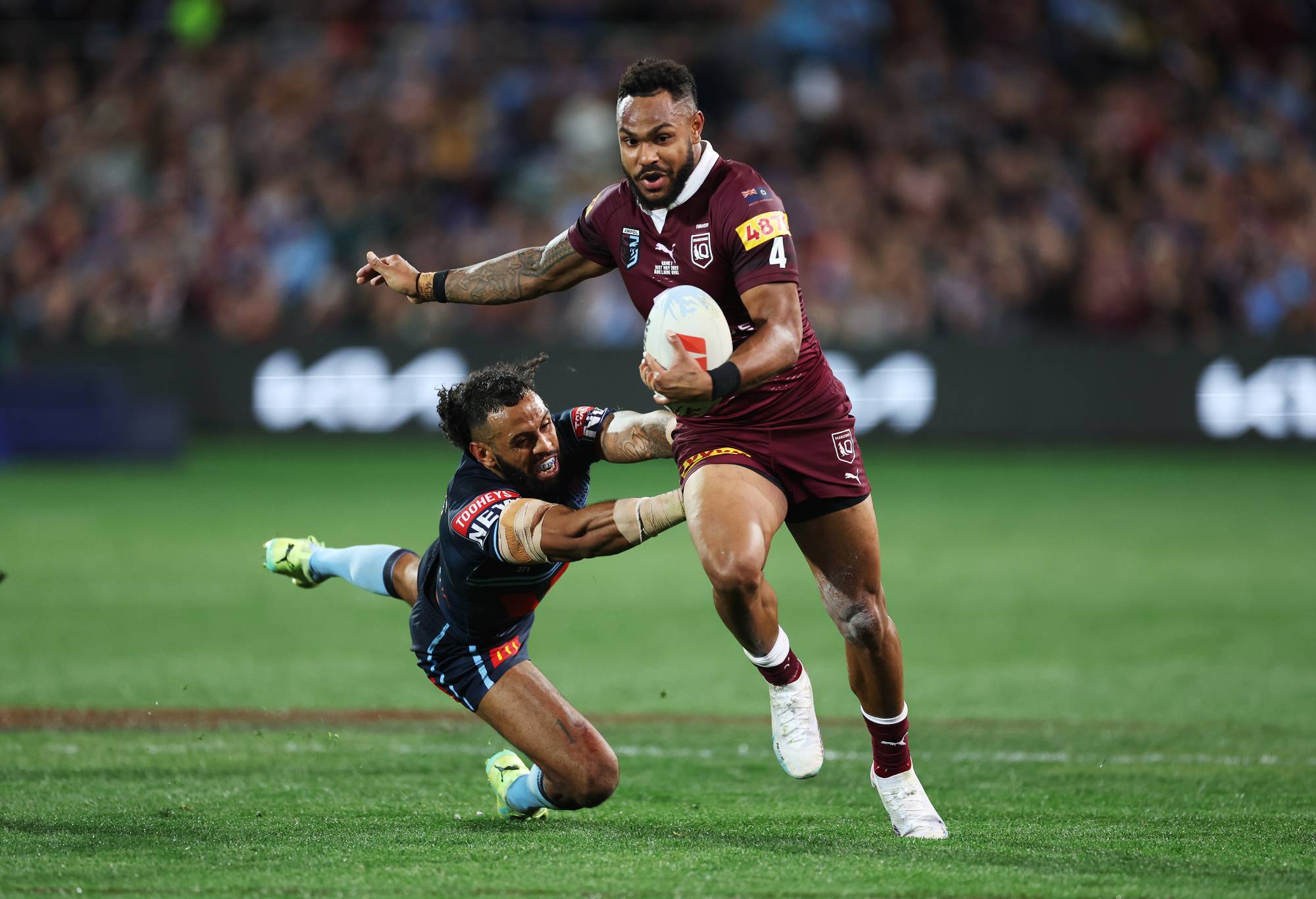 Hamiso Tabuai-Fidow of the Maroons beats the tackle of Josh Addo-Carr of the Blues before scoring a try during game one of the 2023 State of Origin series between the Queensland Maroons and New South Wales Blues at Adelaide Oval on May 31, 2023 in Adelaide, Australia. (Photo by Mark Kolbe/Getty Images)