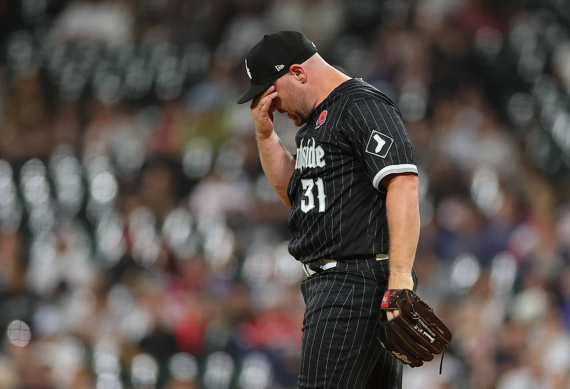 Chicago White Sox relief pitcher Liam Hendriks (31) makes a play at first base during a Major League Baseball game between the Los Angeles Angels and the Chicago White Sox on May 29, 2023 at Guaranteed Rate Field in Chicago, IL. (Photo by Melissa Tamez/Icon Sportswire via Getty Images)