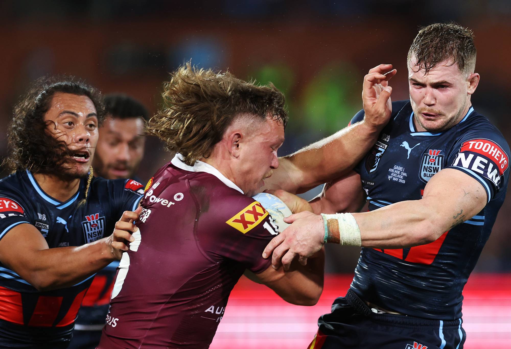 Reuben Cotter of the Maroons is tackled by Hudson Young and Jarome Luai of the Blues during game one of the 2023 State of Origin series between the Queensland Maroons and New South Wales Blues at Adelaide Oval on May 31, 2023 in Adelaide, Australia. (Photo by Mark Kolbe/Getty Images)