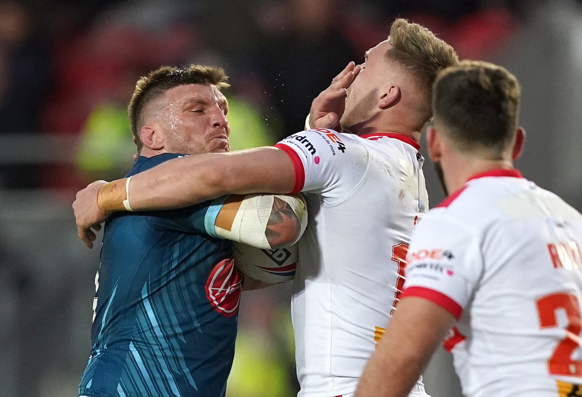 Warrington Wolves' Josh McGuire is tackled by St Helens Saints' Matty Lees, during the Betfred Super League match at the Totally Wicked Stadium, St Helens. Picture date: Thursday April 20, 2023. (Photo by Martin Rickett/PA Images via Getty Images)