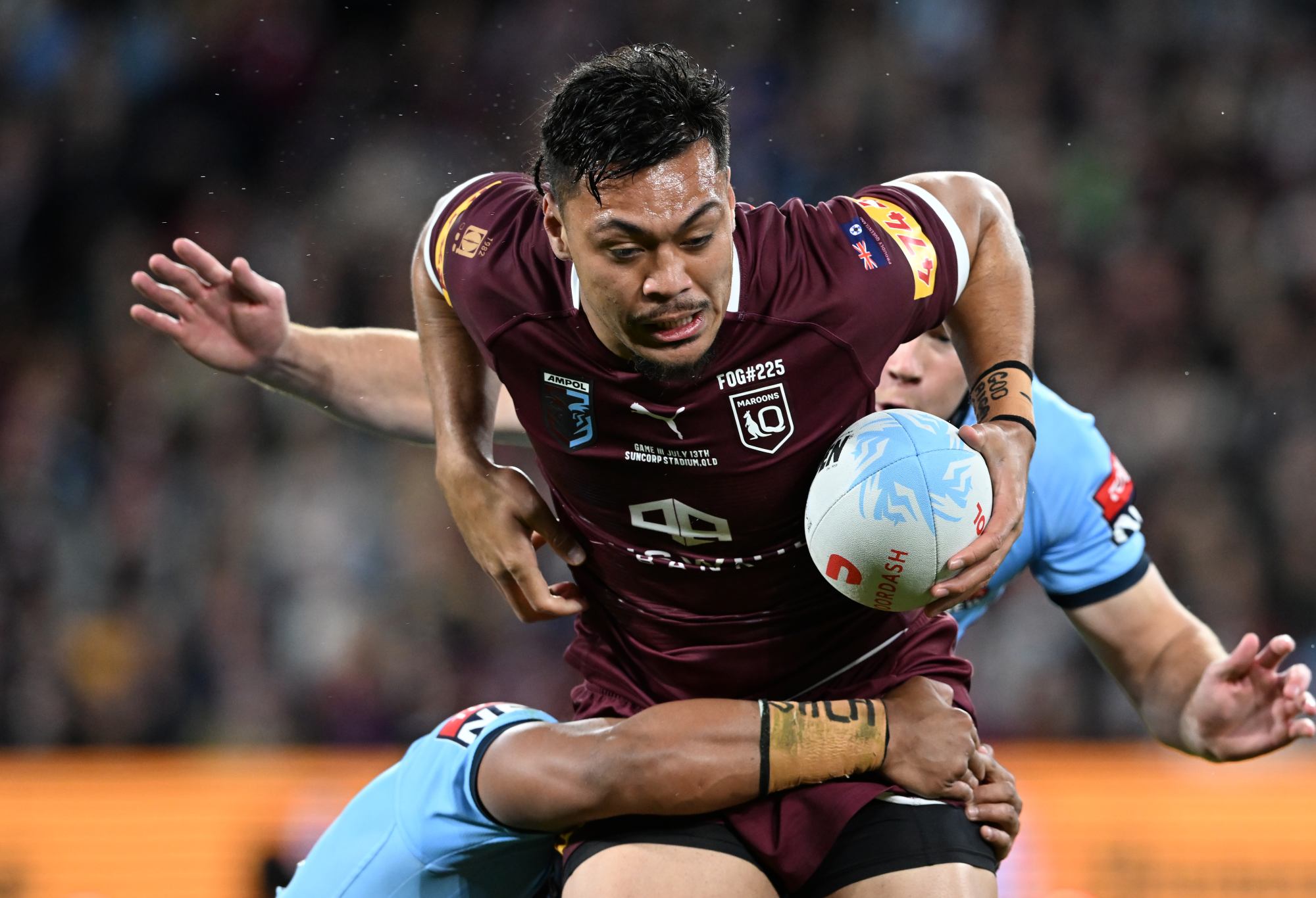 BRISBANE, AUSTRALIA - JULY 13: Jeremiah Nanai of the Maroons is tackled during game three of the State of Origin Series between the Queensland Maroons and the New South Wales Blues at Suncorp Stadium on July 13, 2022 in Brisbane, Australia. (Photo by Bradley Kanaris/Getty Images)