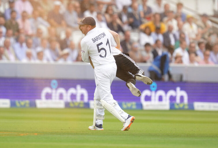 Jonny Bairstow carries a Just Stop Oil protestor off the pitch at Lord's.