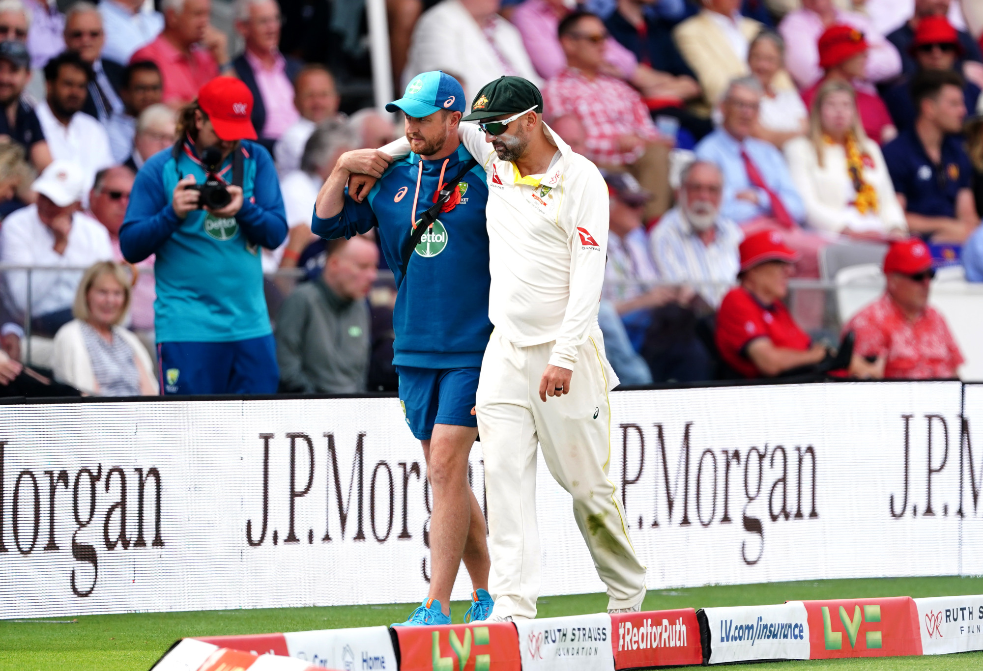 Nathan Lyon is helped from the field.