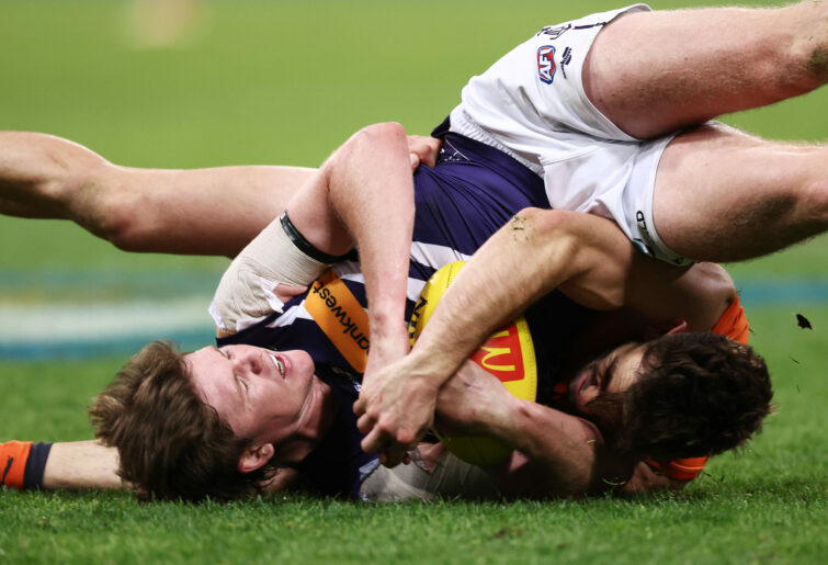 Nathan O'Driscoll is tackled by Stephen Coniglio.